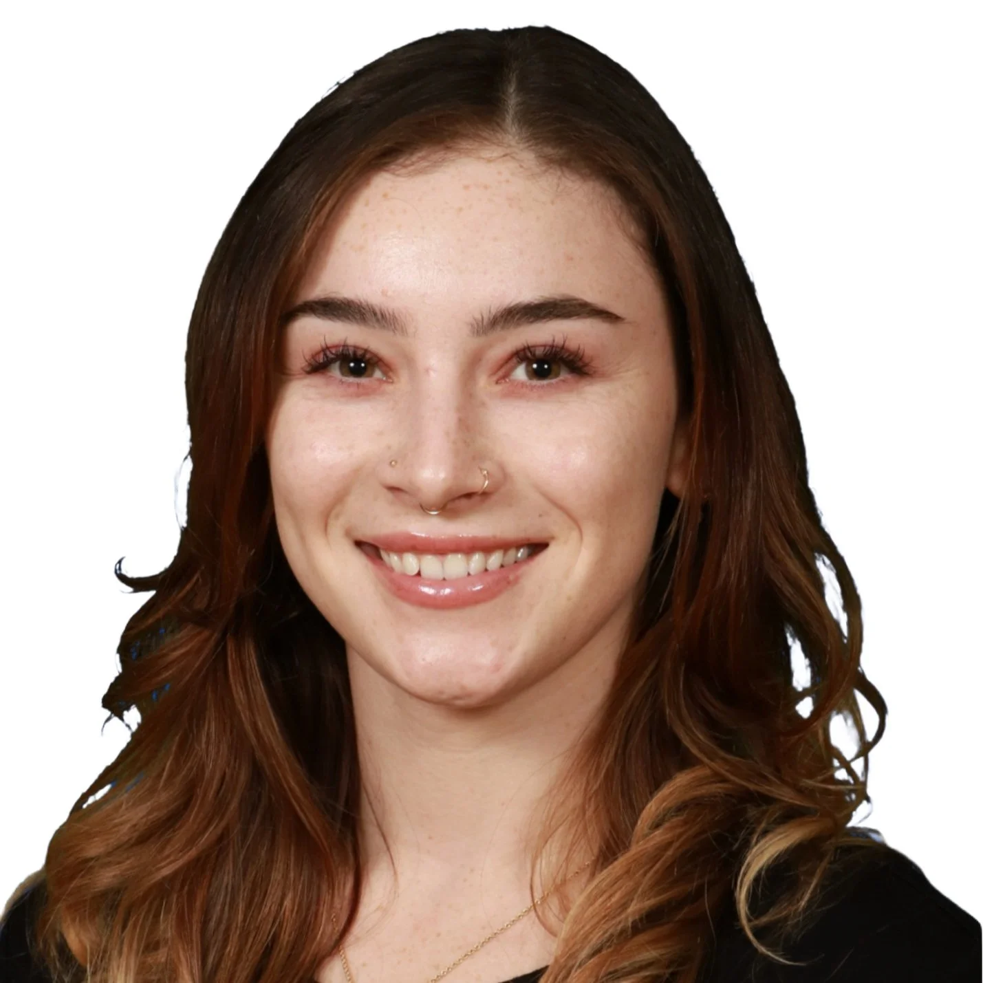Portrait of a young woman with long brown hair, wearing a nose ring and smiling against a plain white background.