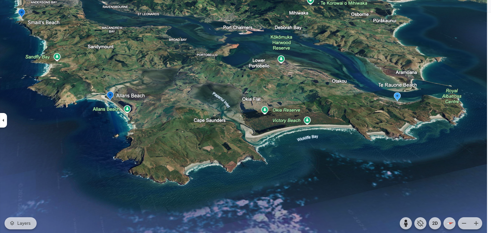 A detailed 3D map of a coastal region showing beaches, bays, and inland water bodies with labels for various landmarks, beaches, reserves, and towns in a lush green landscape.