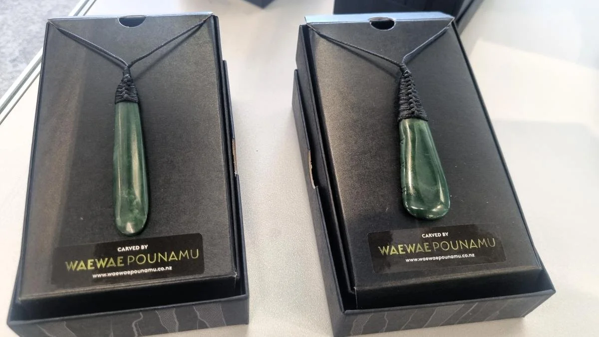 Two pounamu pendants on display.