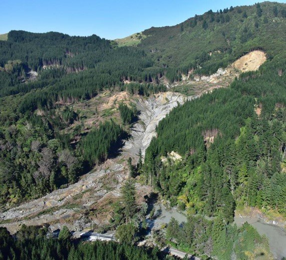 A large landslide in a forested area.
