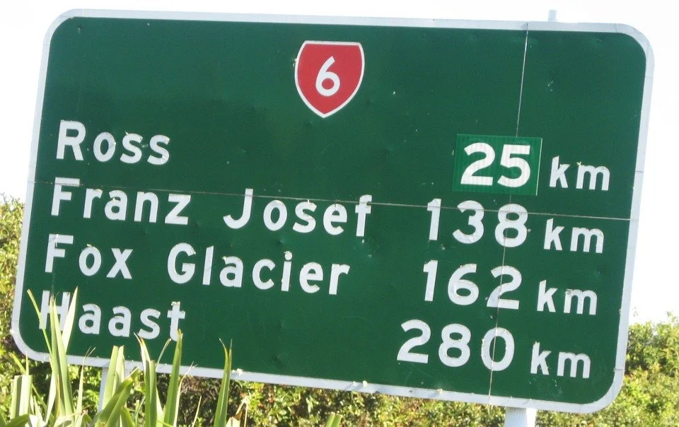 Road sign showing place names on the West Coast of the South Island.