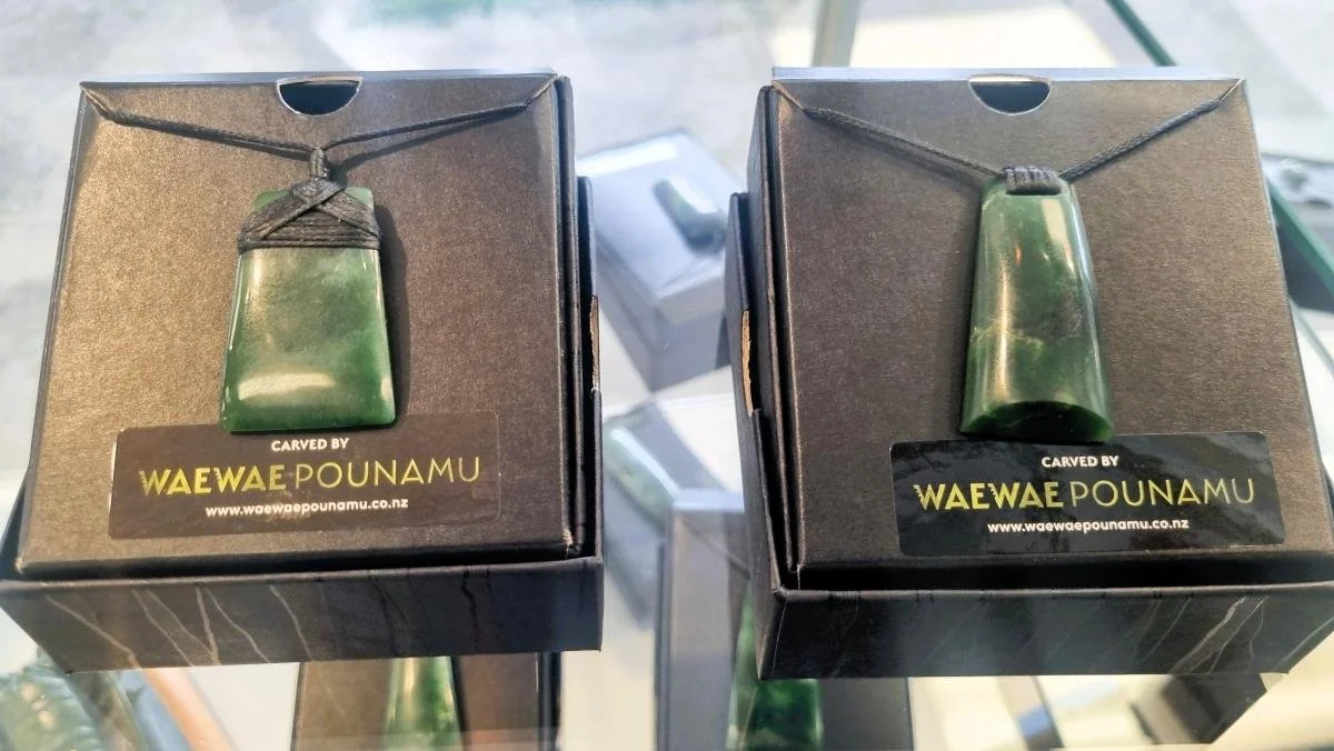Two pounamu 'toki' pendants box displayed for sale.