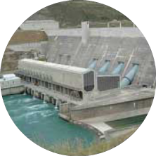 Hydroelectric dam releasing water through turbines
