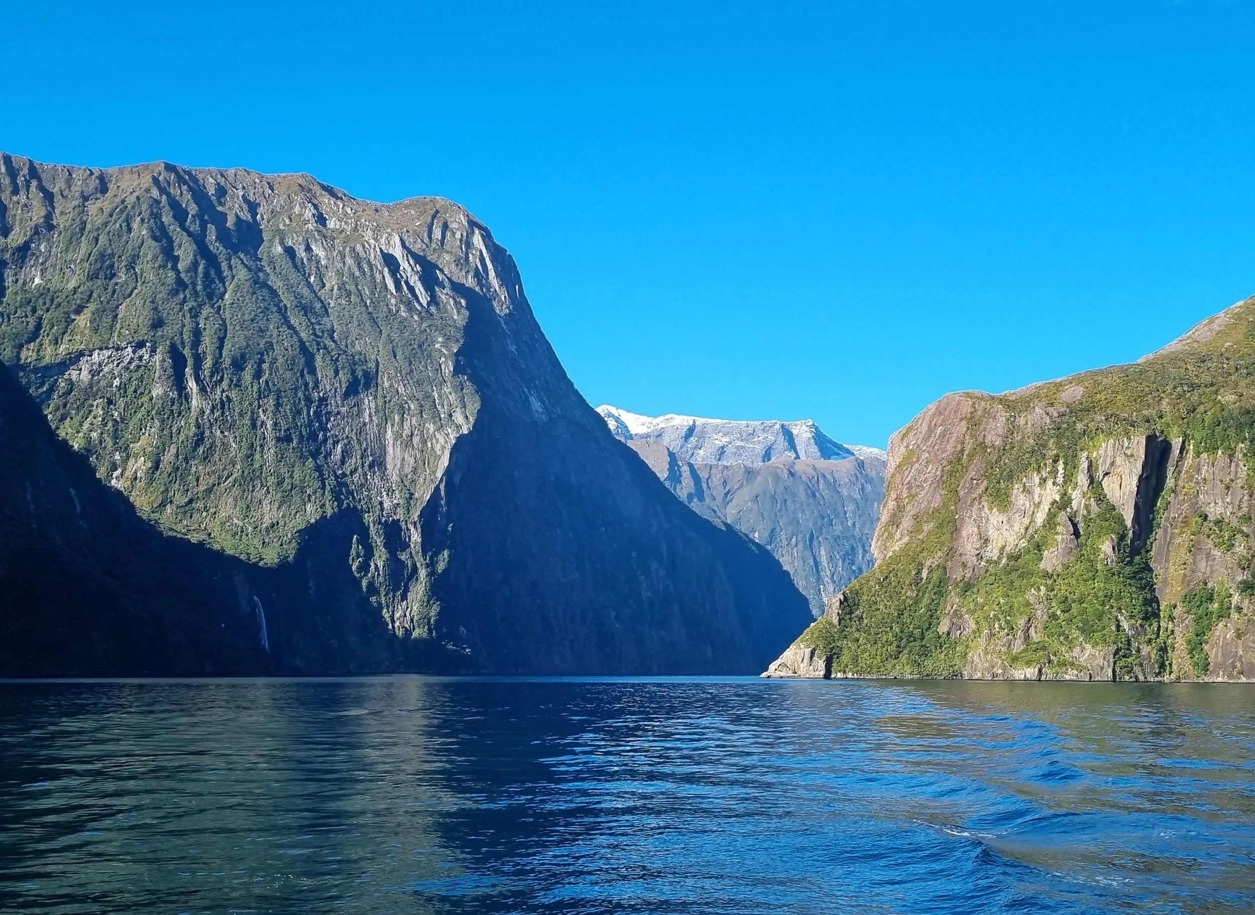 An image of Piopiotahi Milford Sound, a fiord with steep valley walls carved by an ancient glacier.