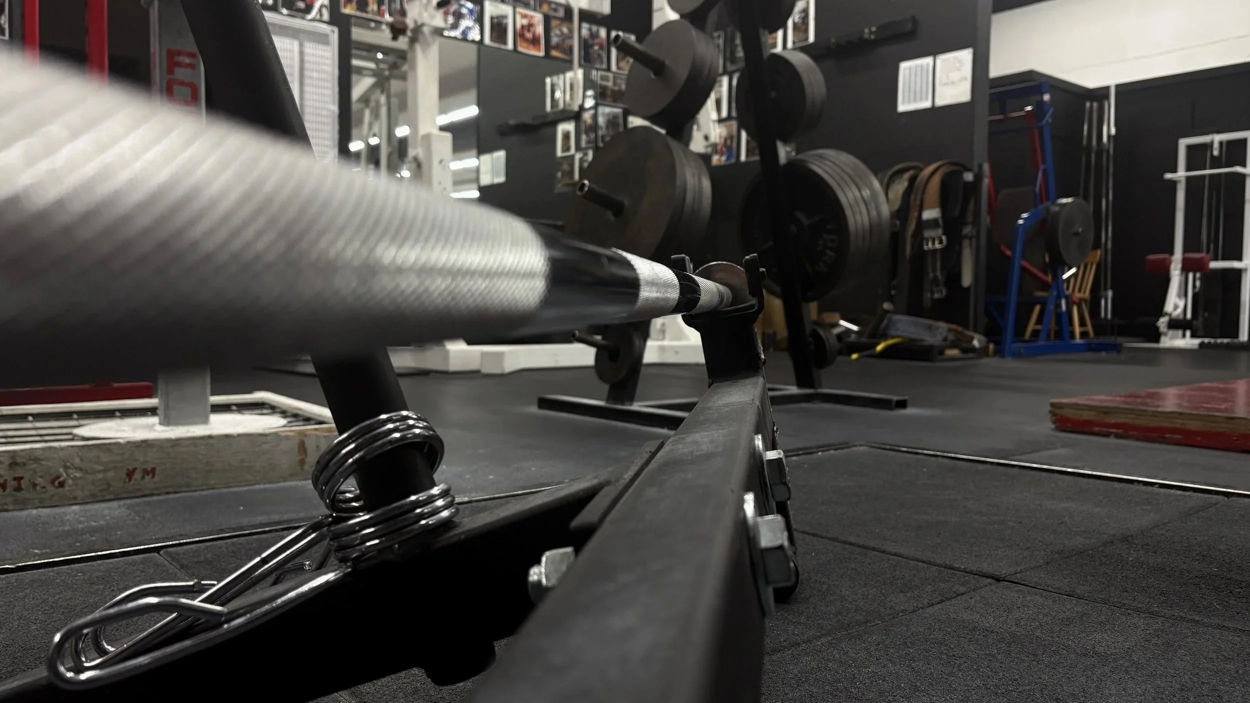 Barbell and weight plates in the strength training area at Downing’s Gym Corvallis.