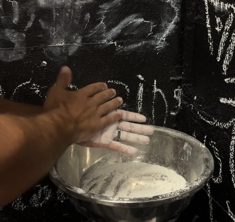 Lifter chalking their hands before training at Downing's Gym.