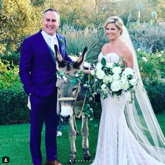Groom in custom indigo suit at wedding