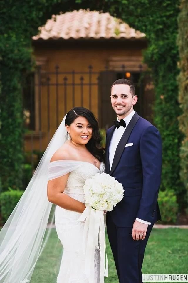 Groom wearing navy custom tuxedo and bowtie