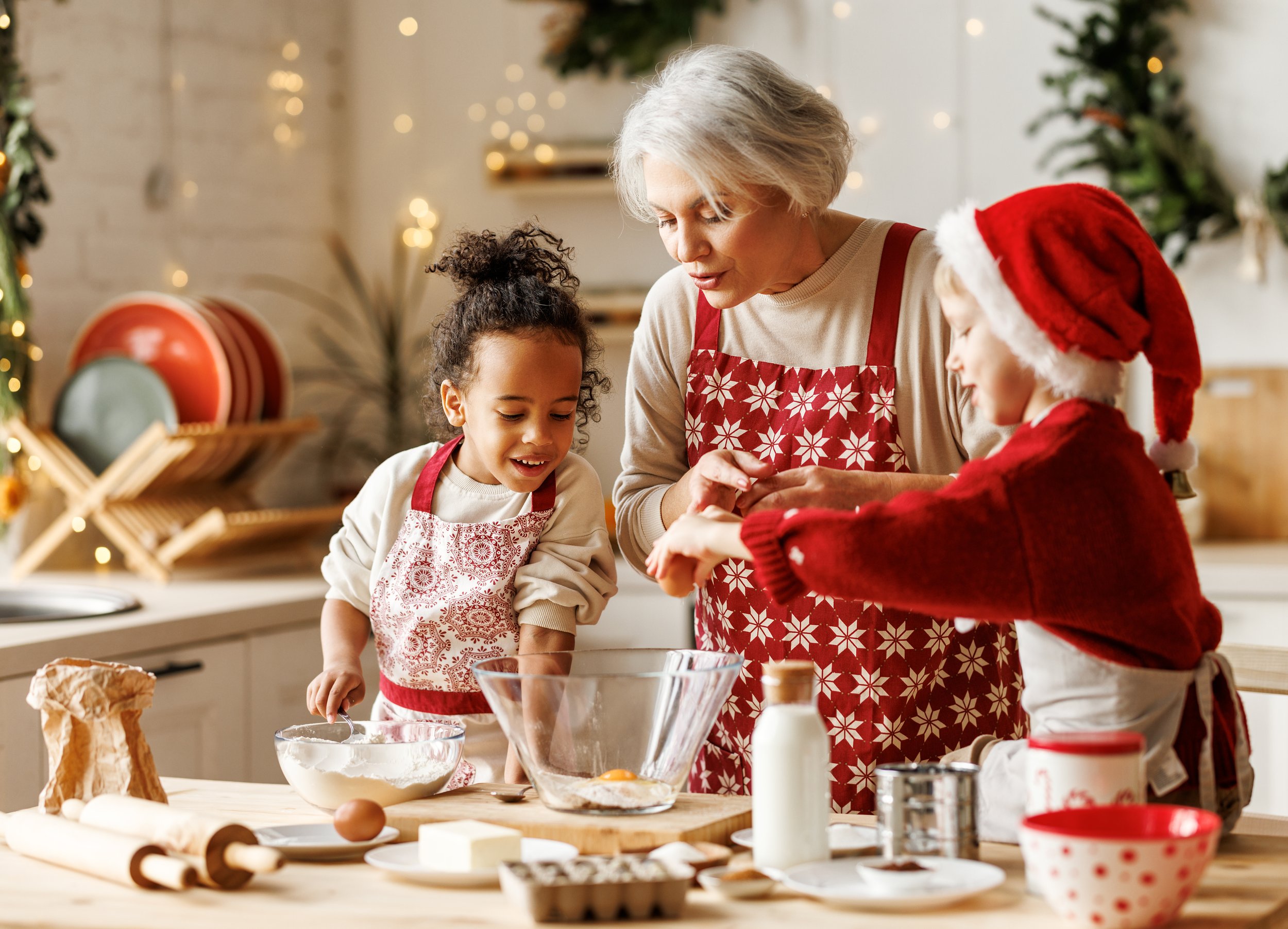 Children baking cookies in a holiday kitchen.