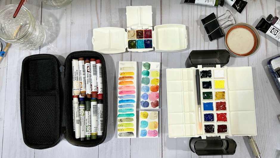 A birds-eye-view of watercolor paints in a travel paint palette
