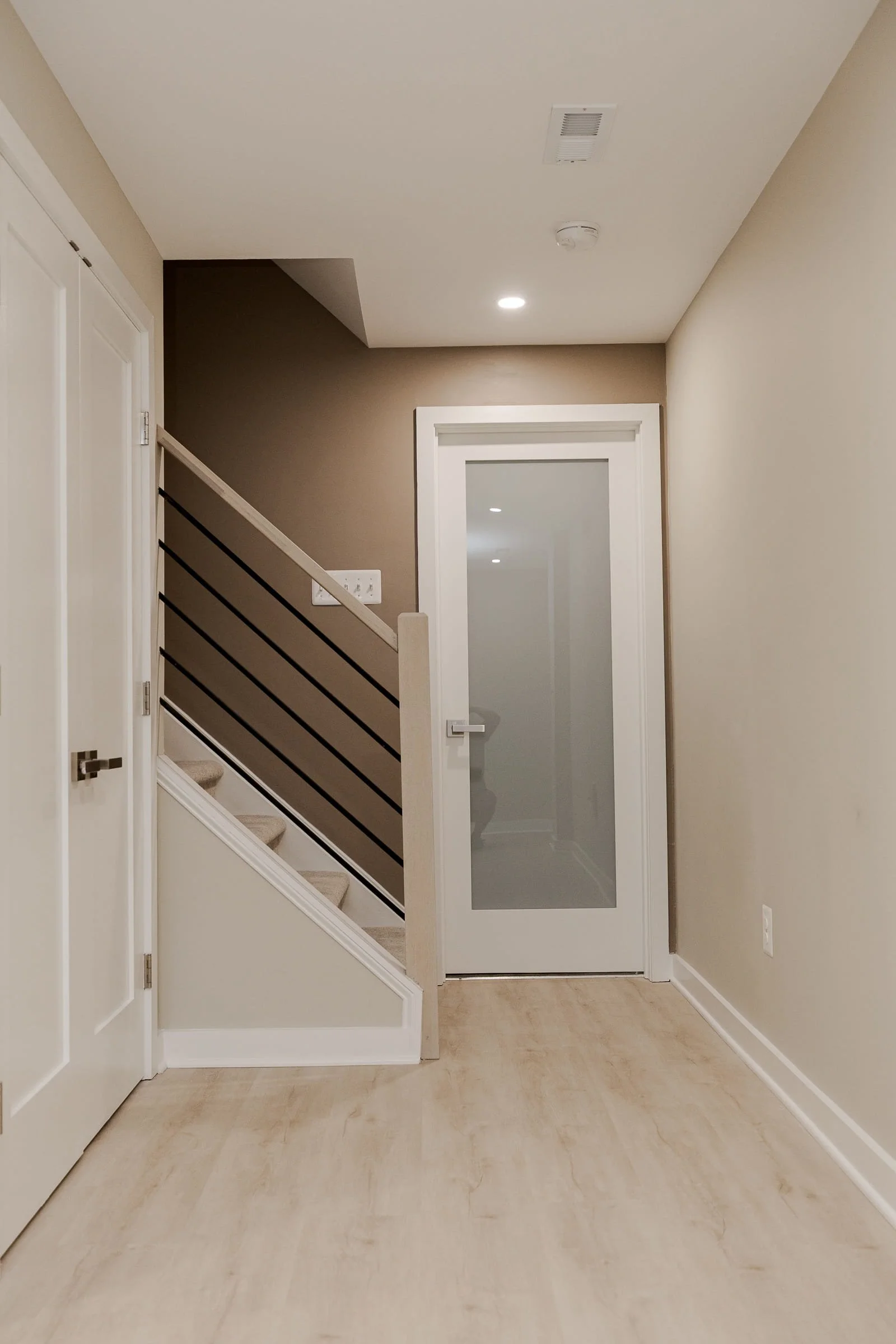 basement finishing Langley, basement renovation contractor Langley, basement finishing Silverthistle Ct, basement kitchenette remodel, Fabuwood Galaxy Mocha basement cabinets, basement walkout entrance addition, Studio Tifton luxury vinyl plank basem