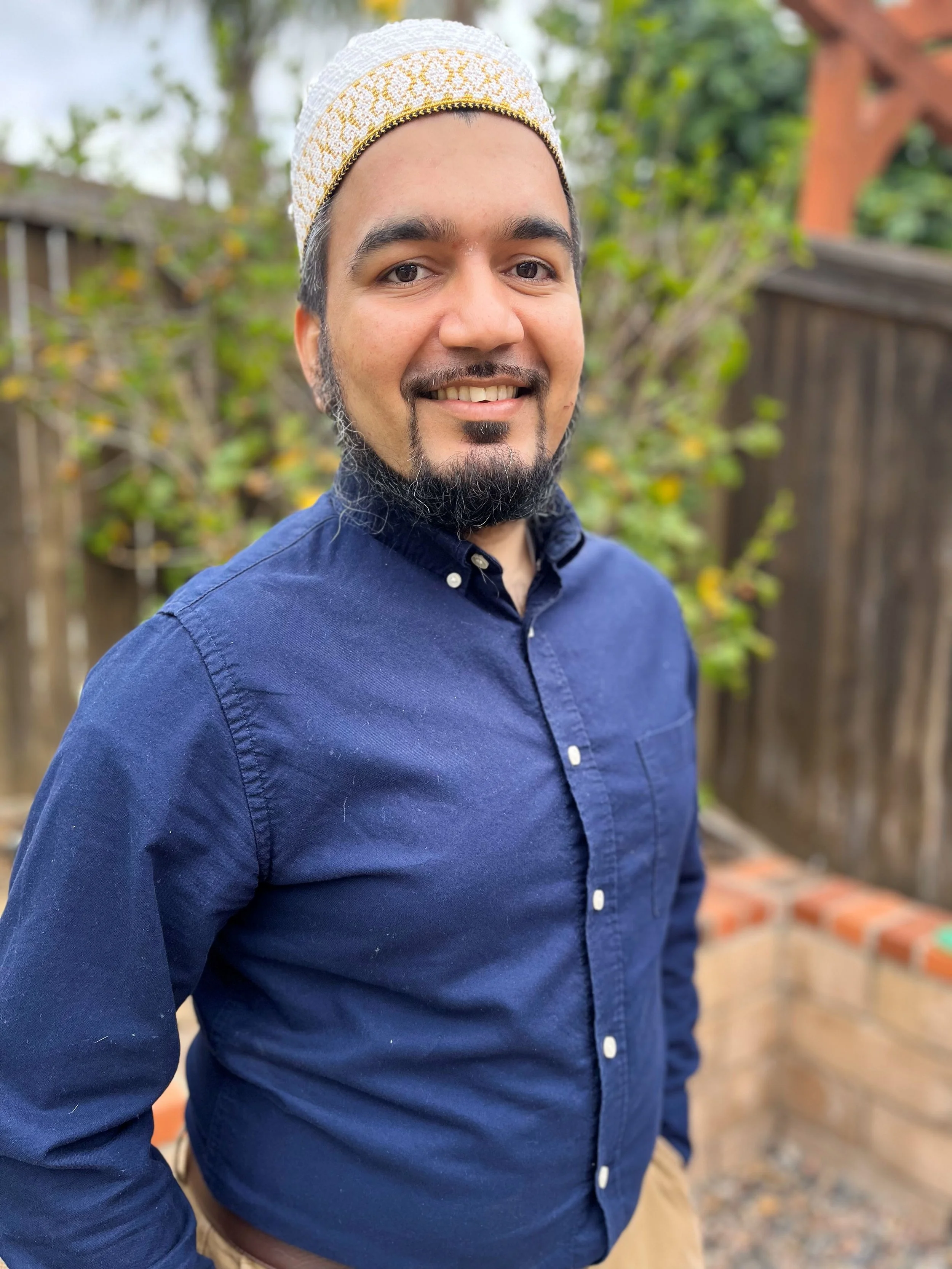 Man smiling in a blue shirt