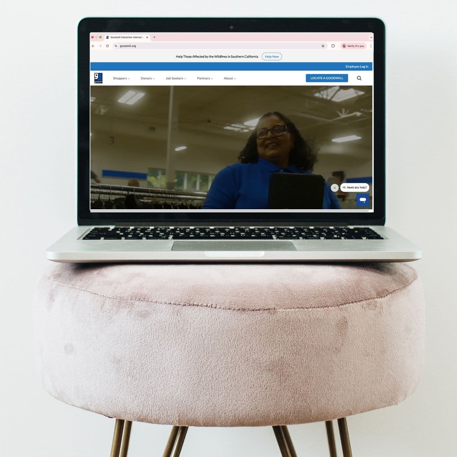 Laptop on a stool displaying the Goodwill website interface, illustrating the accessible and mainstream experience of Goodwill thrift stores.