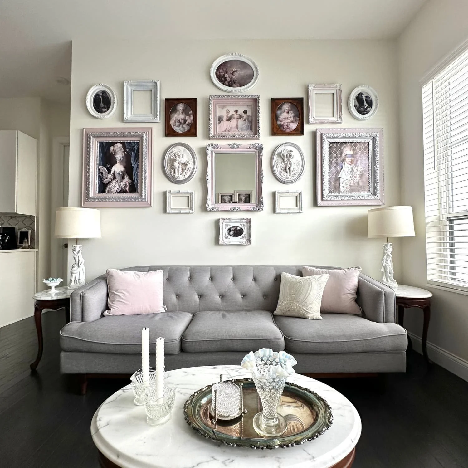 Living room furnished almost entirely with secondhand pieces—excluding the couch, throw pillows, and some art prints—demonstrating how decorating sustainably can still look stylish and intentional.