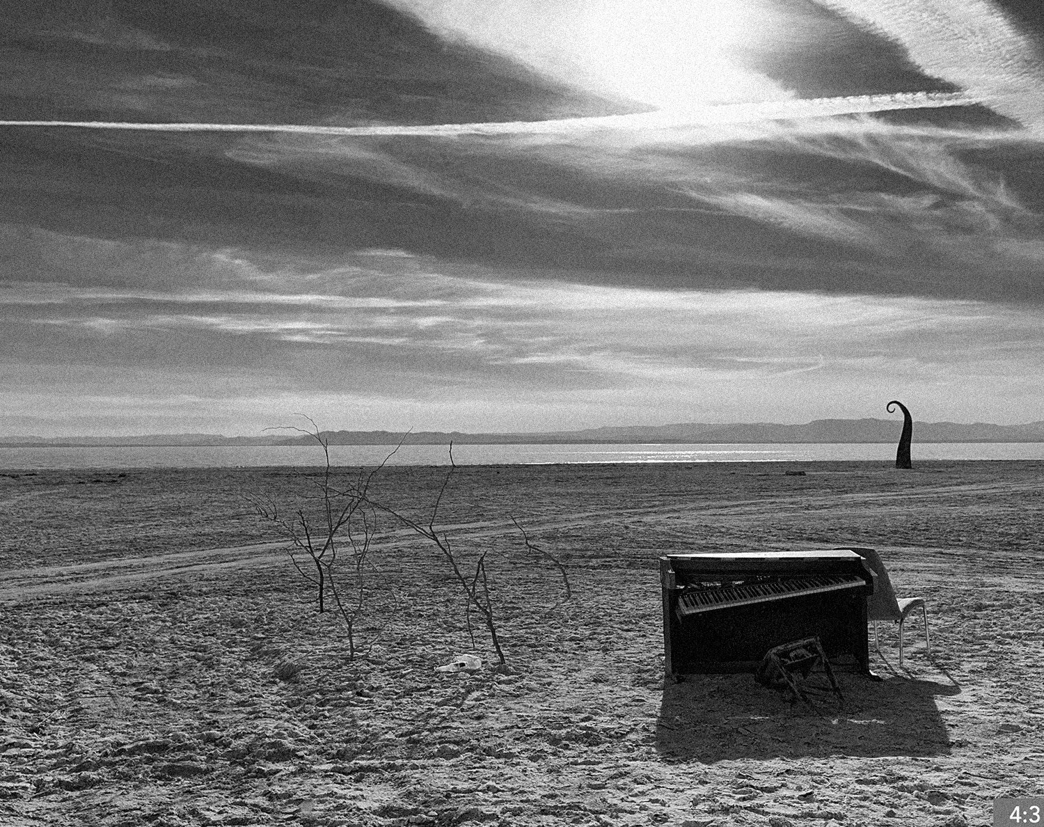84. Salton Sea 3. SHOT: LONG/MEDIUM/CLOSE: father plays his guitar for daughter in front of art installation