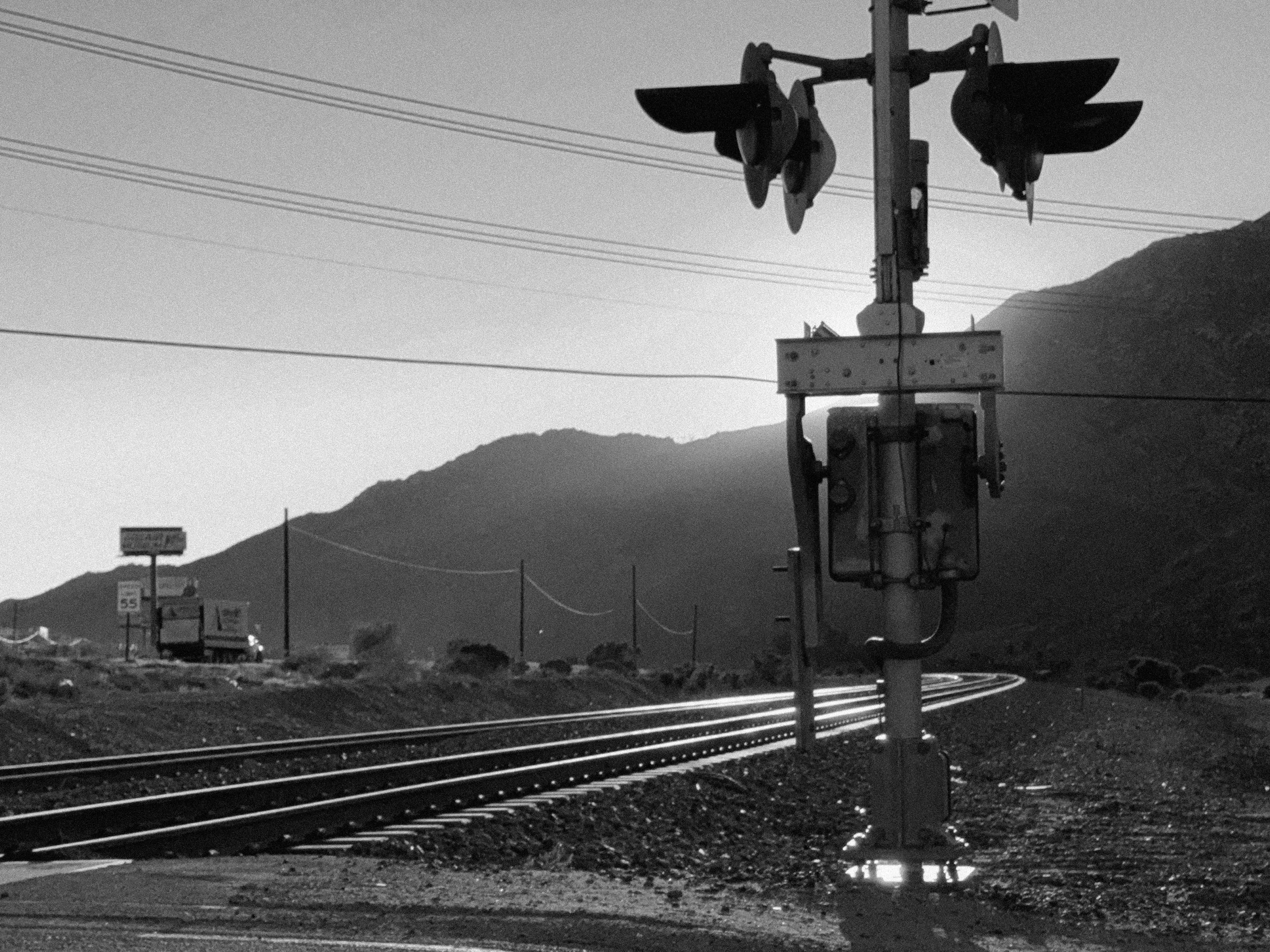 35. Morongo train tracks 7 am 13990 Apache trail Cabazon, CA 92230  1. SHOT 6 - CLOSE ON a different older pair of boots without a tag walking on the tracks. PUSH OUT revealing it is sometime later. The man wears different clothes. He does not hold a
