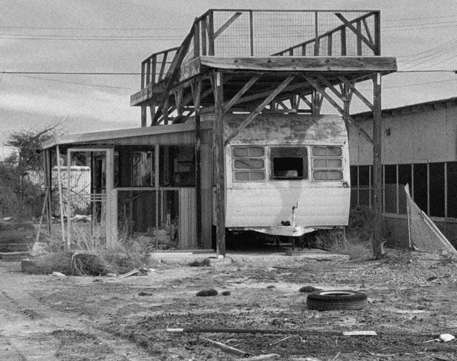 67. Salton Sea 2. SHOT LONG MEDIUM CLOSE: Daughter stands in a doorway of an abandoned shack.
5. SHOT LONG MEDIUM CLOSE: father sits on steps of broken down trailer smoking when a bubble floats beside him
