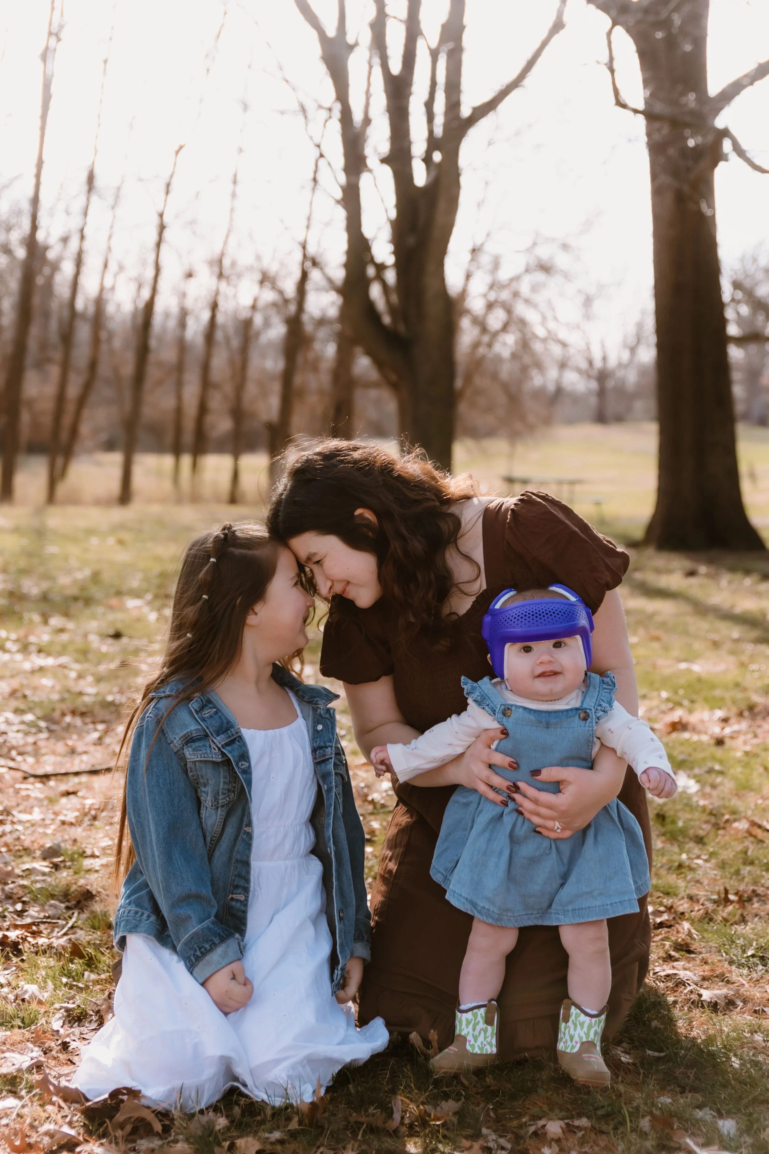 family of five posing together in wooded area central illinois