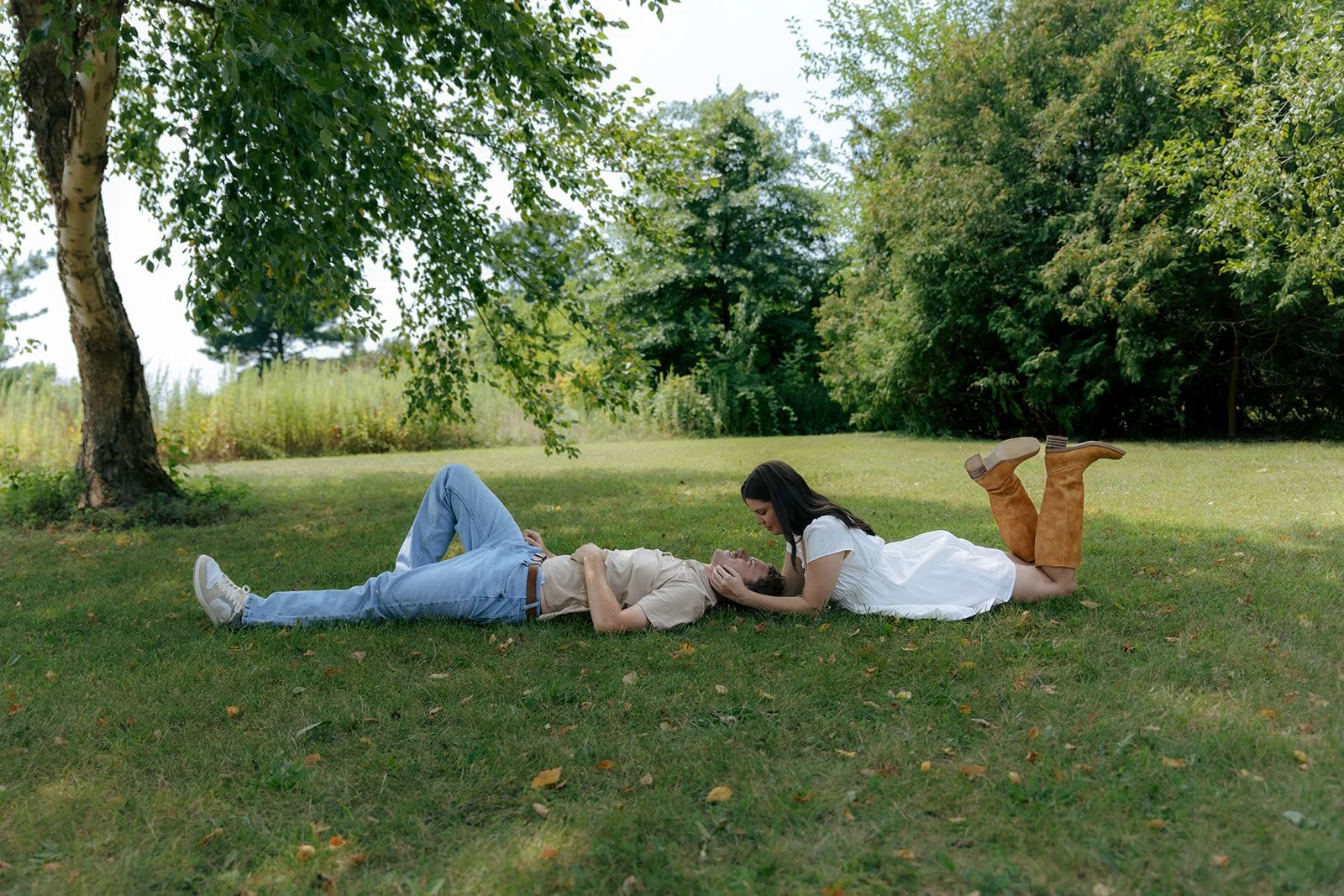 Couple laying in grass during sunset photos in Peoria Illinois