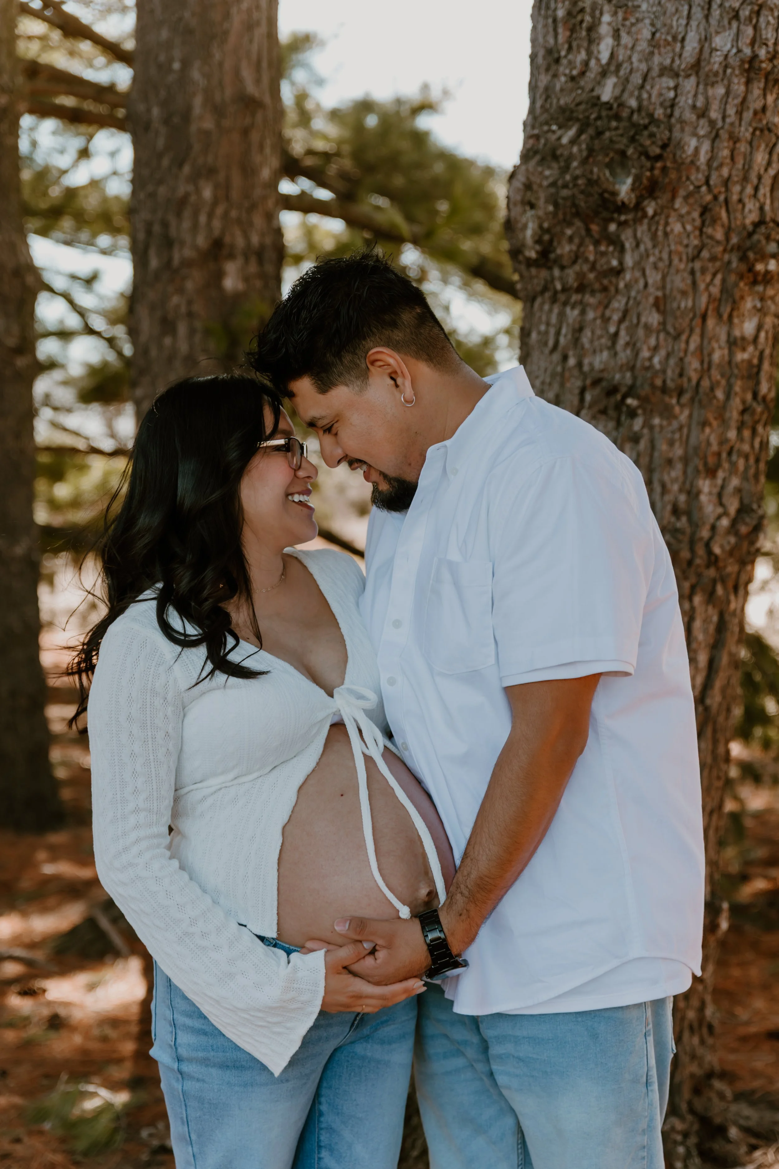 couple touching foreheads during maternity session