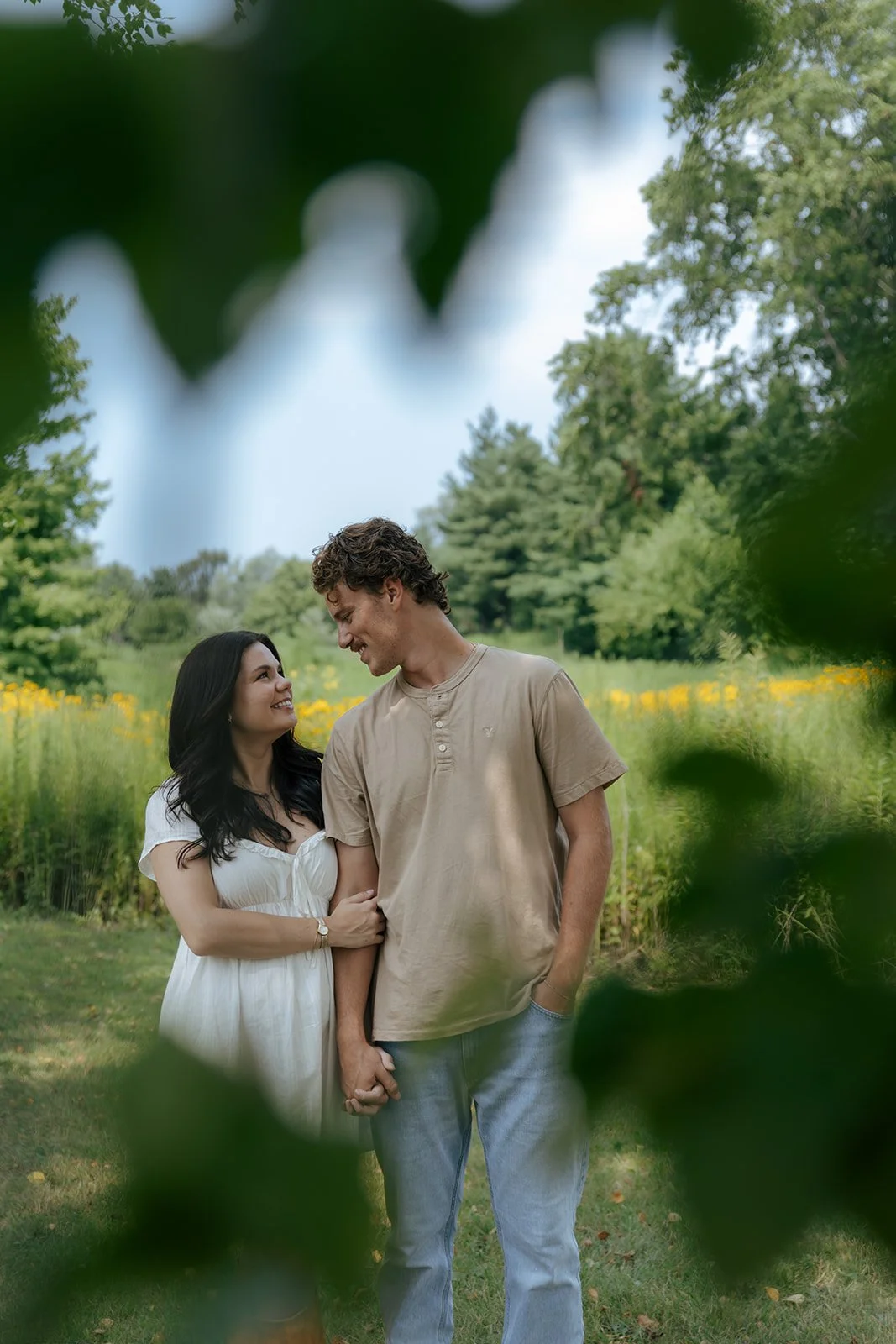 Couple walking together in tall grass field in Peoria Illinois