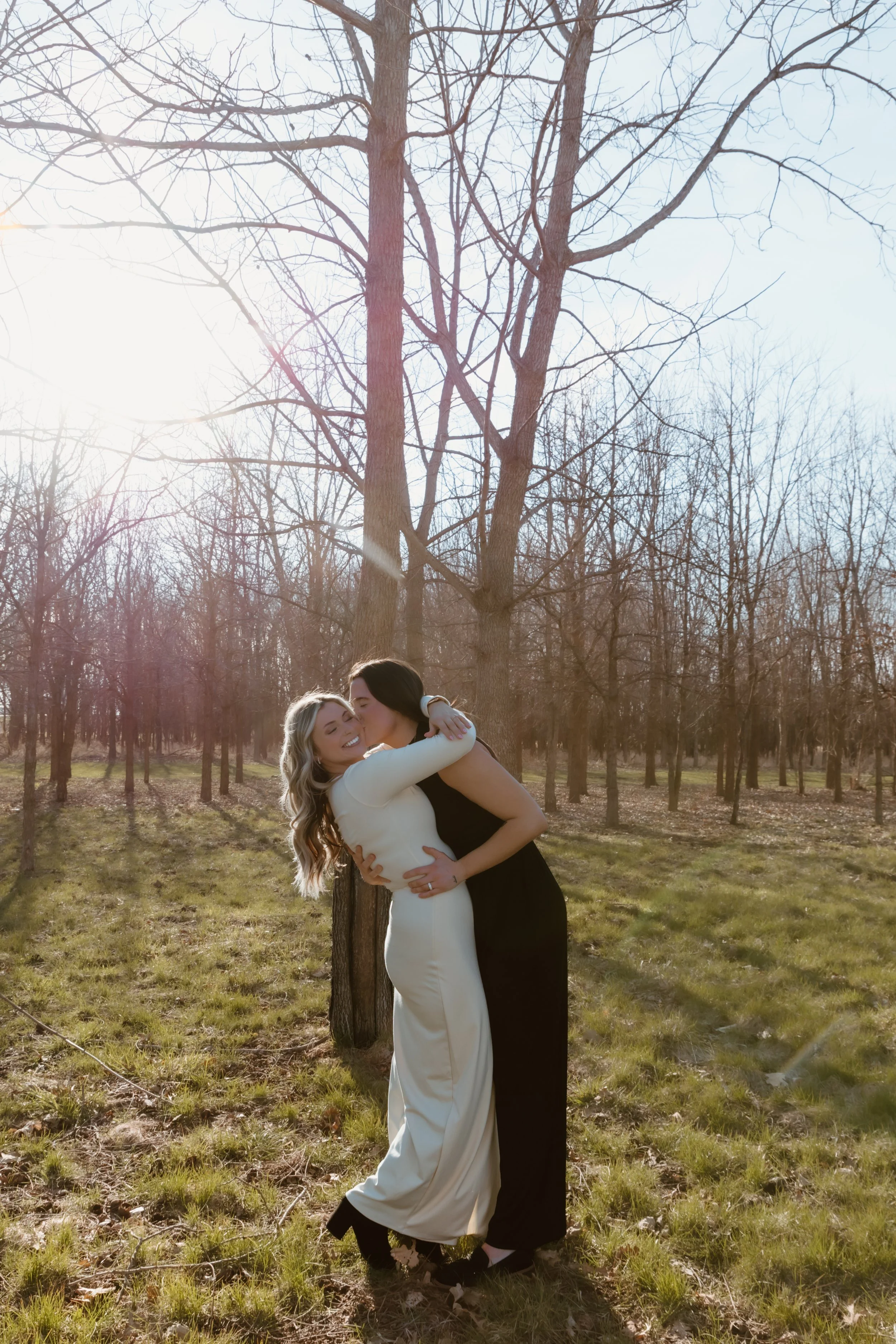 newly engaged couple embracing in golden light after proposal