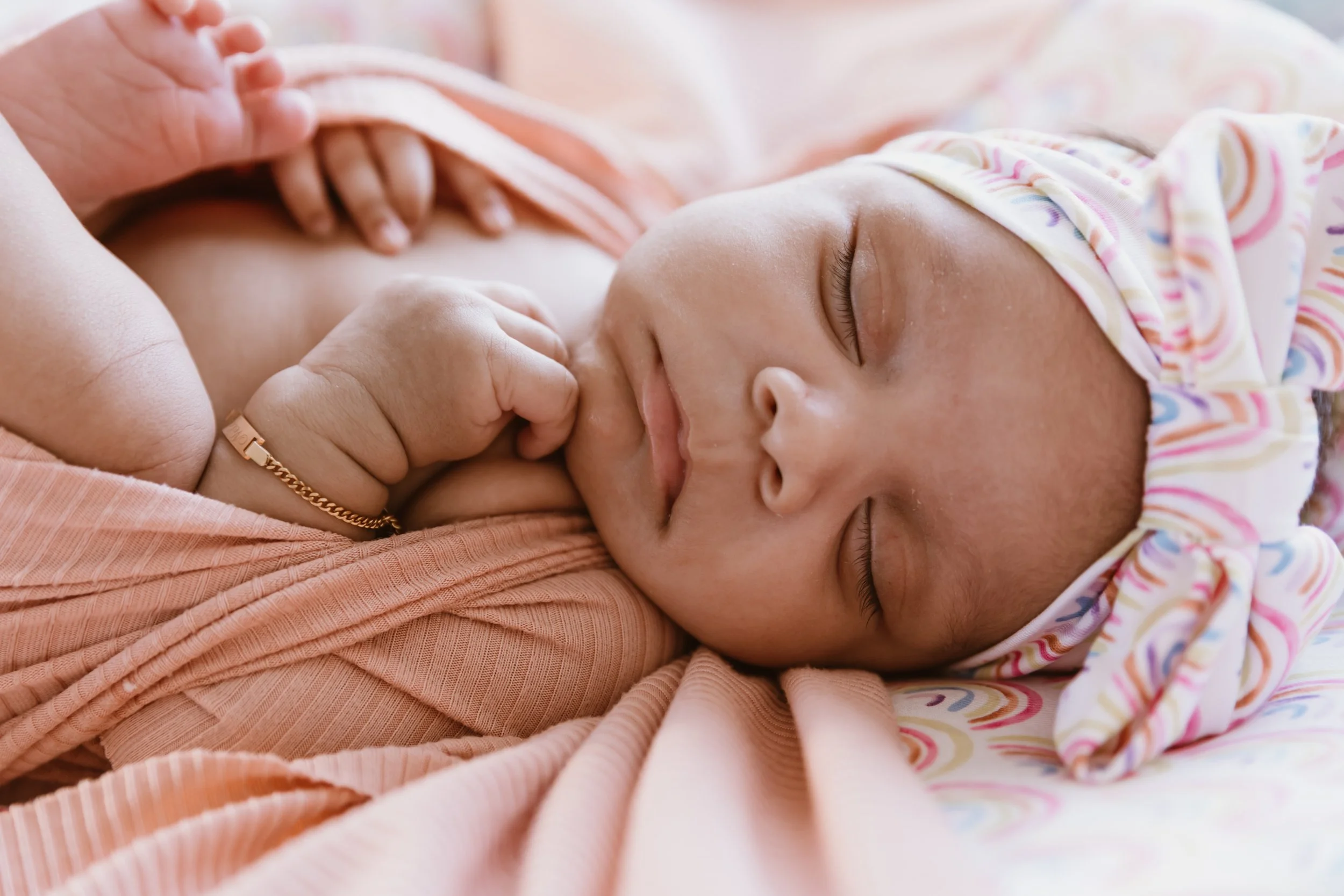 sleeping newborn baby with white bow photographed during Peoria Illinois newborn photography session