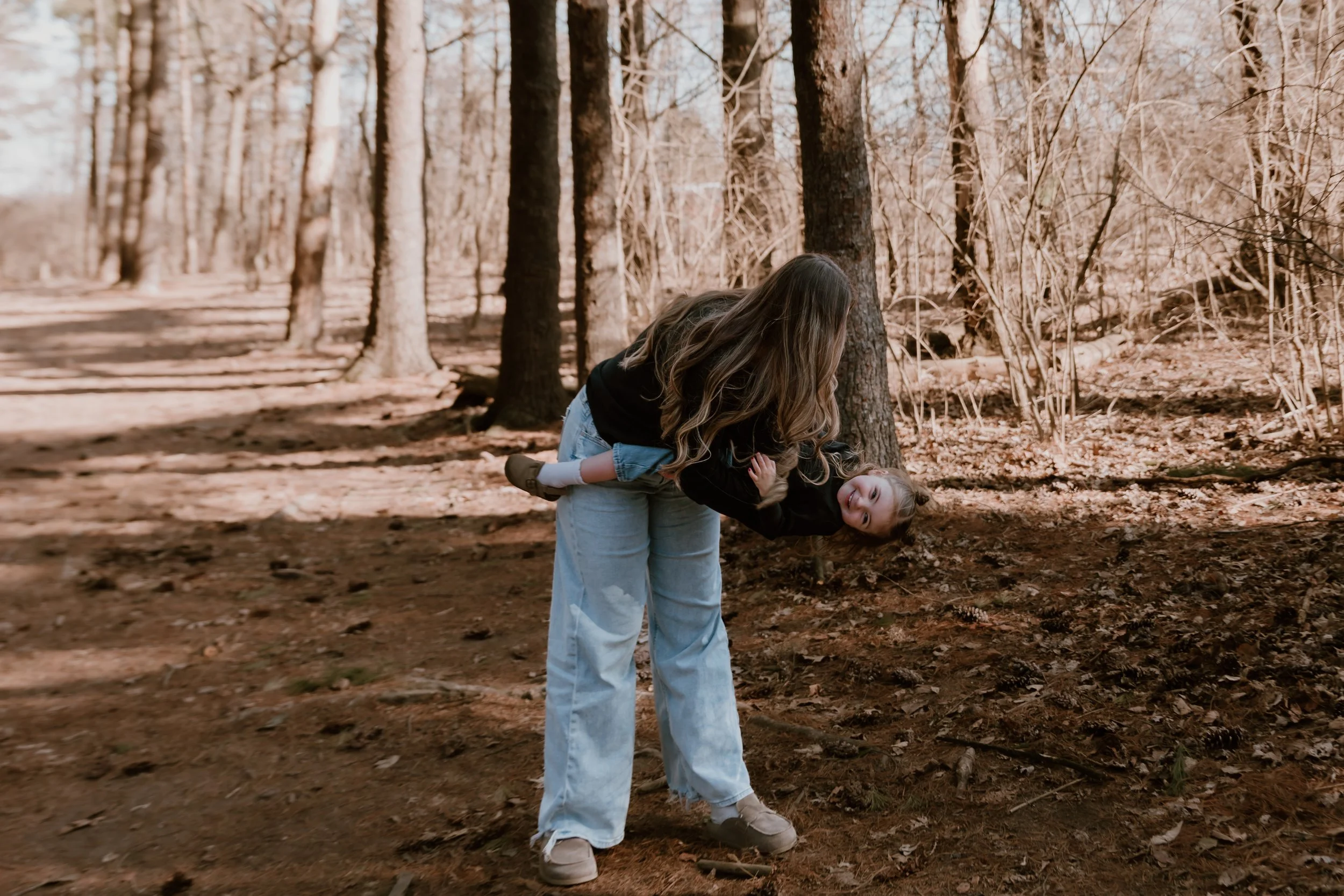 Mother holding her child during an in-home family photography session in Central Illinois, photographed with a natural and storytelling approach.