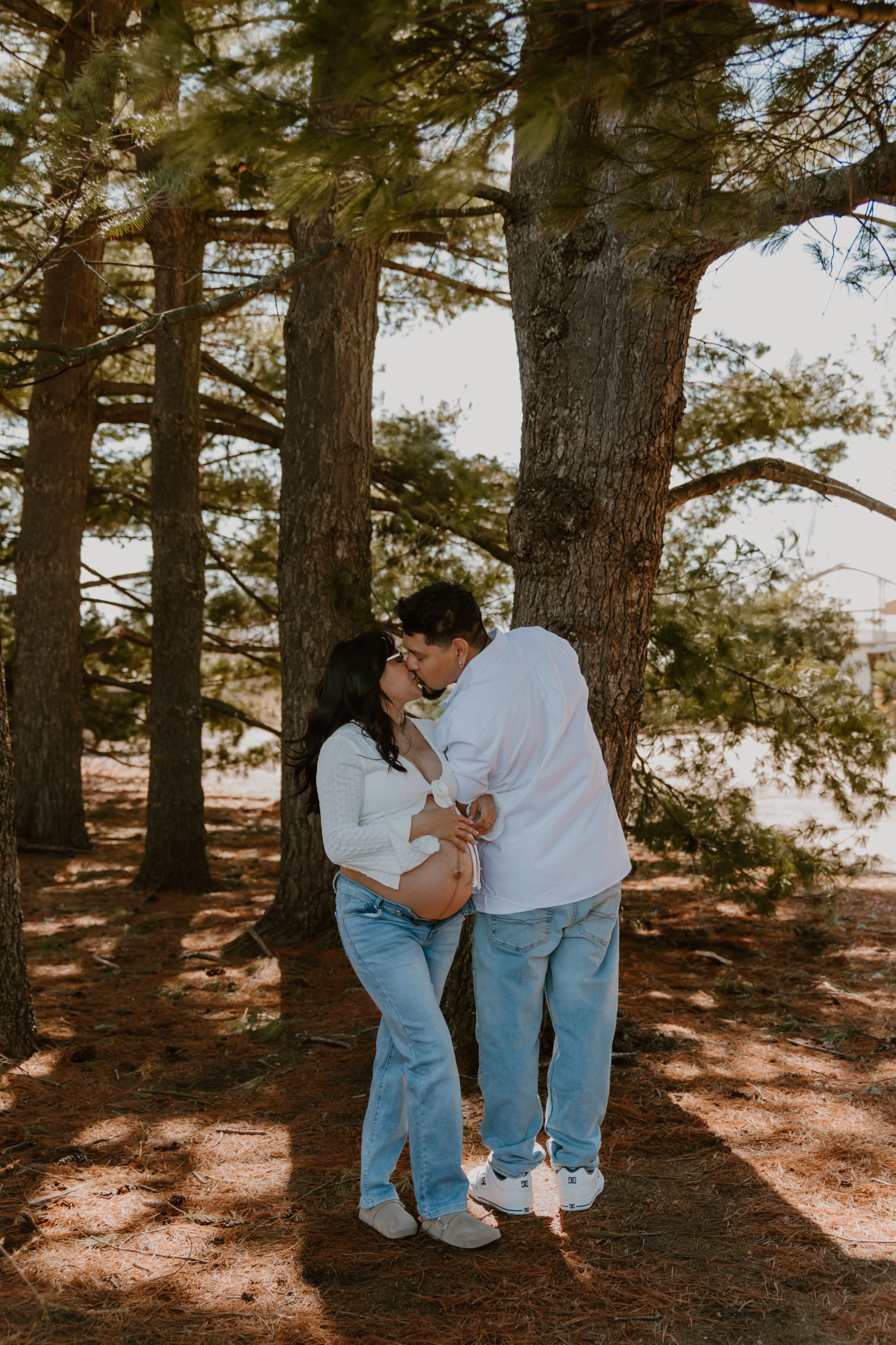 couple kissing during maternity photos