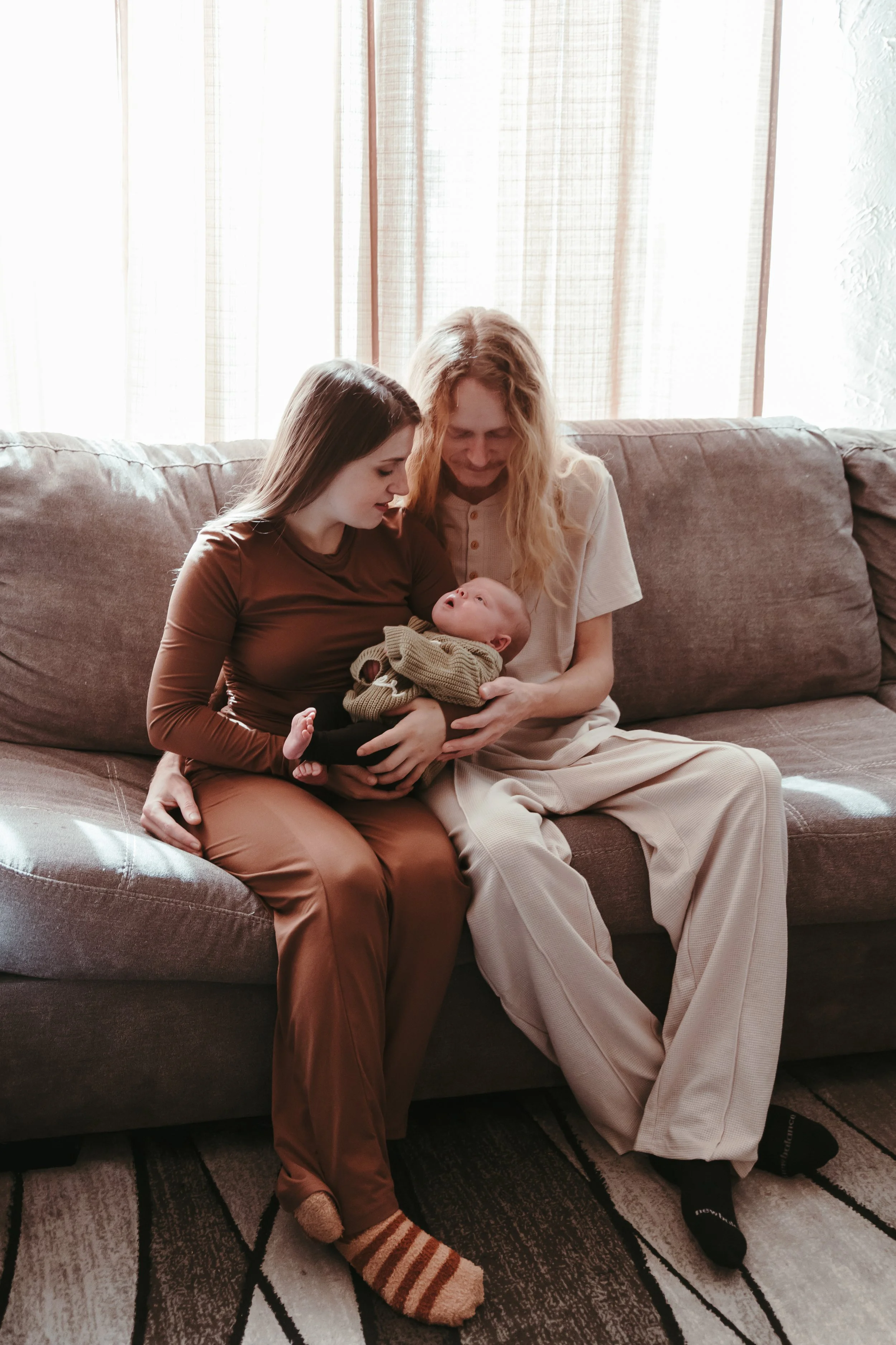 In-home newborn session in Peoria Illinois with family on couch