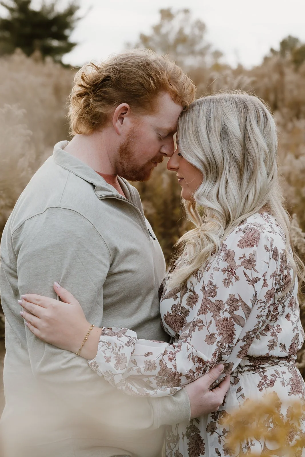 Couple standing in tall fall grass in Central Illinois during golden hour couples session
