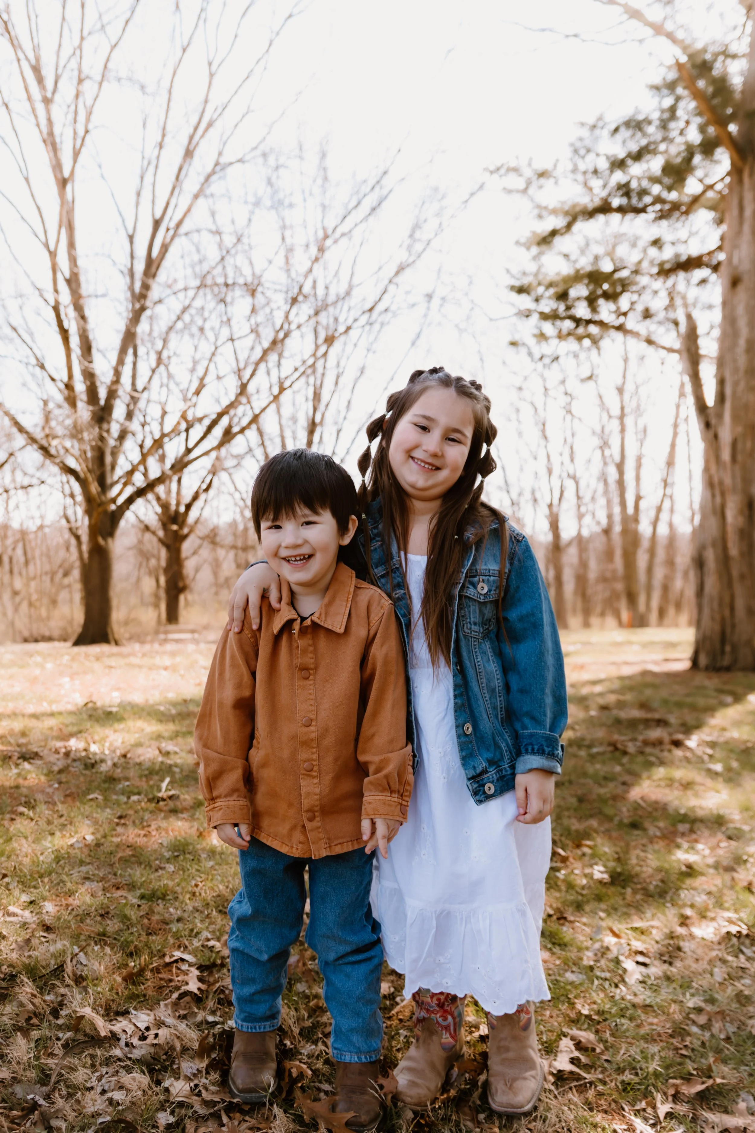 family of five posing together in wooded area central illinois