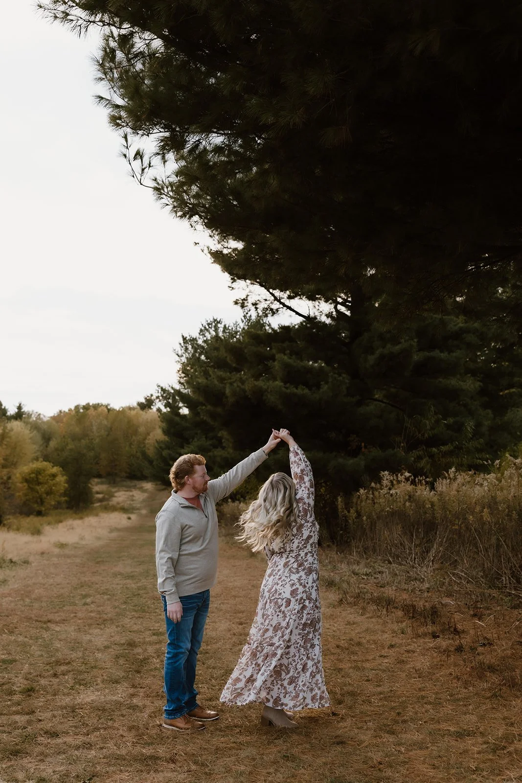 Couple dancing together during outdoor fall photography session in Illinois