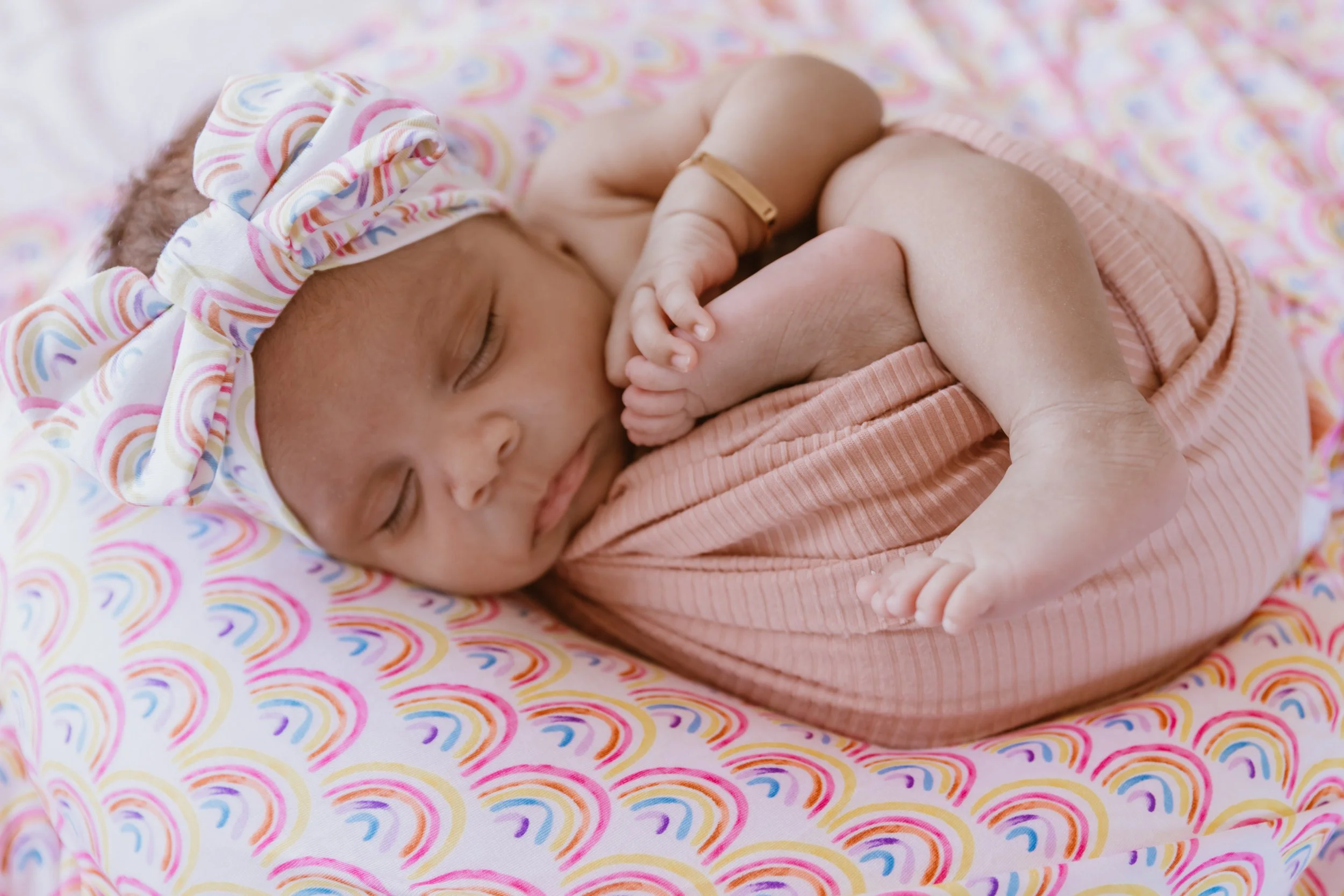 newborn baby wearing engraved bracelet photographed in Central Illinois studio session