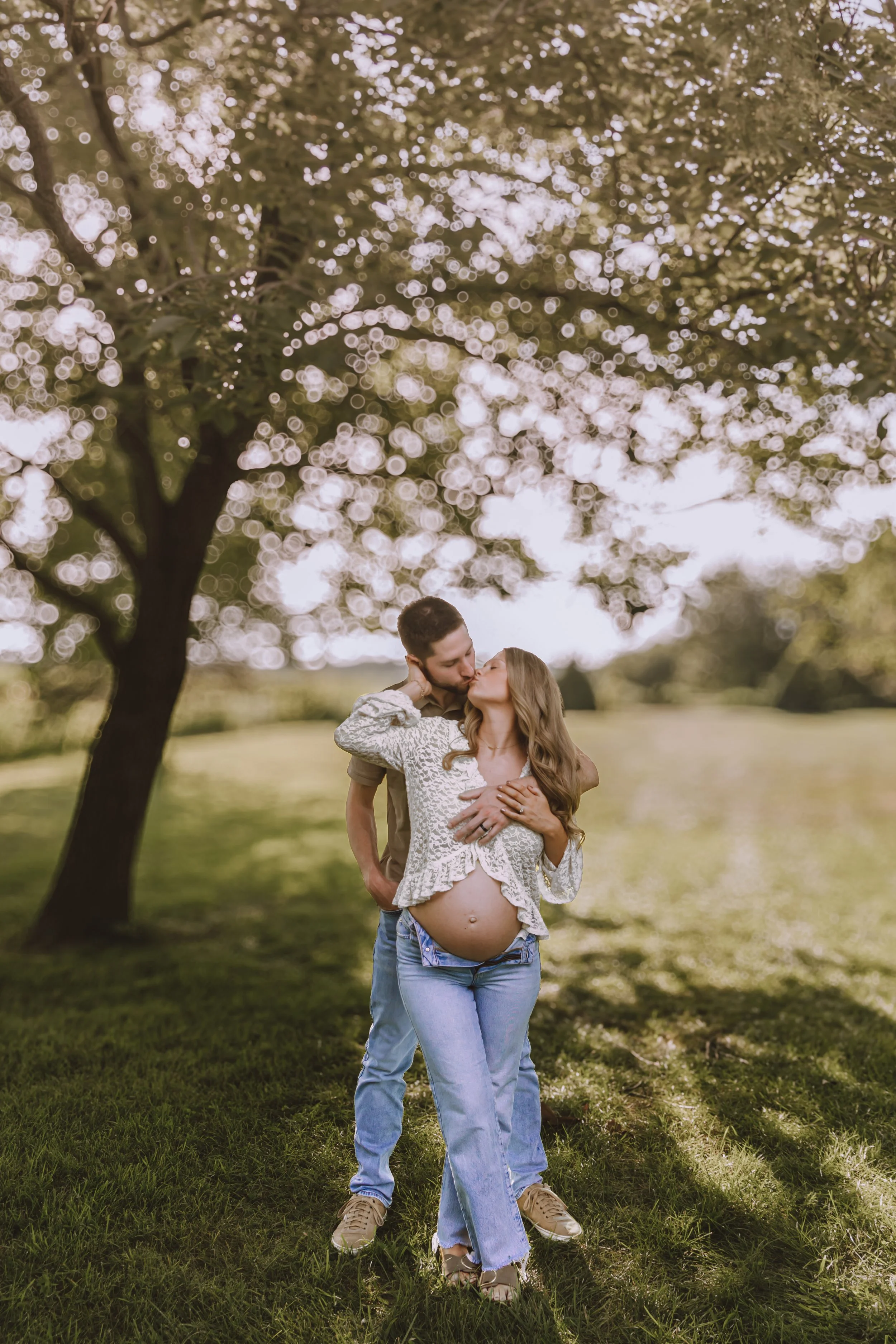 Expecting couple embracing outdoors during a maternity photography session in Central Illinois.