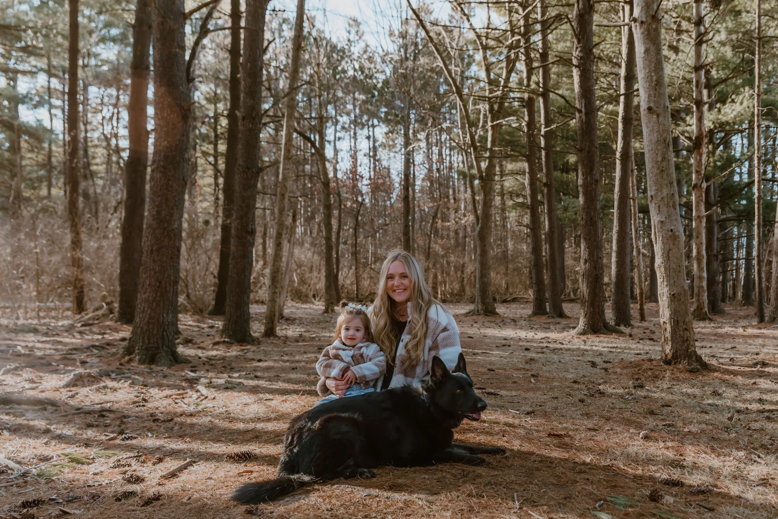 Candid winter family photo of a mom holding her toddler outdoors in Illinois