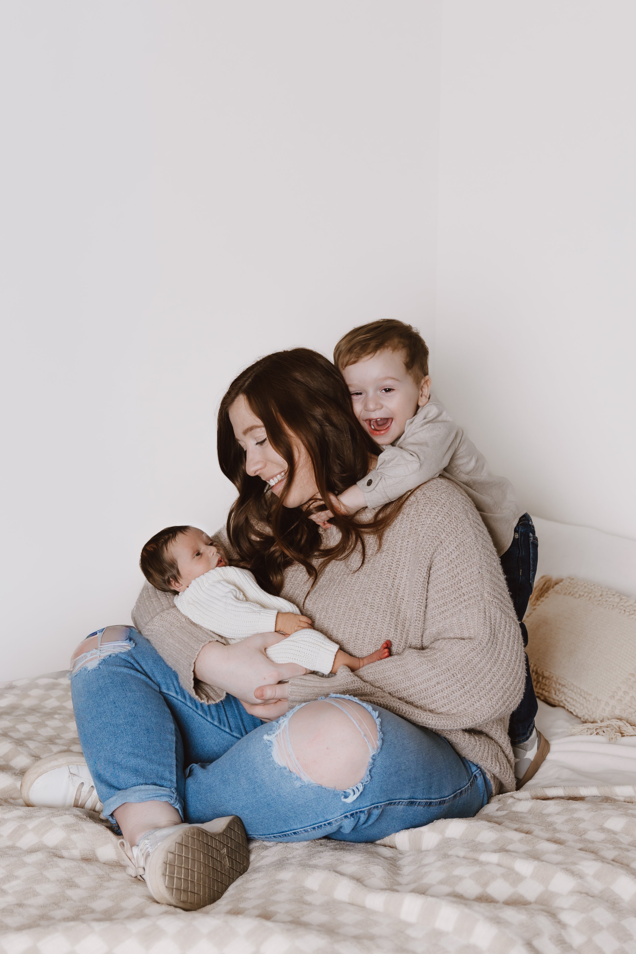 mom holding newborn baby during lifestyle family session