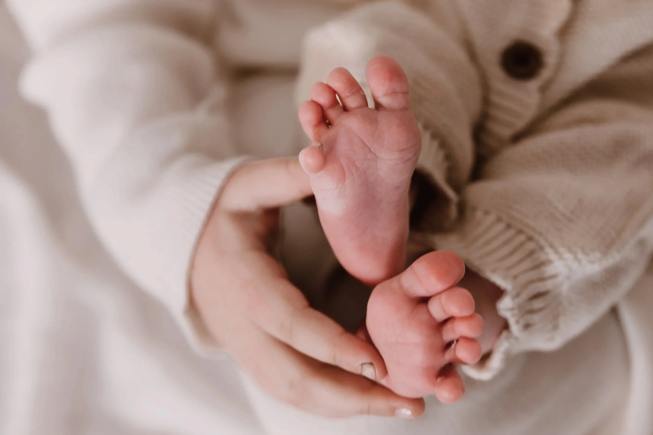 parent holding newborn during a lifestyle newborn photography session in peoria illinois