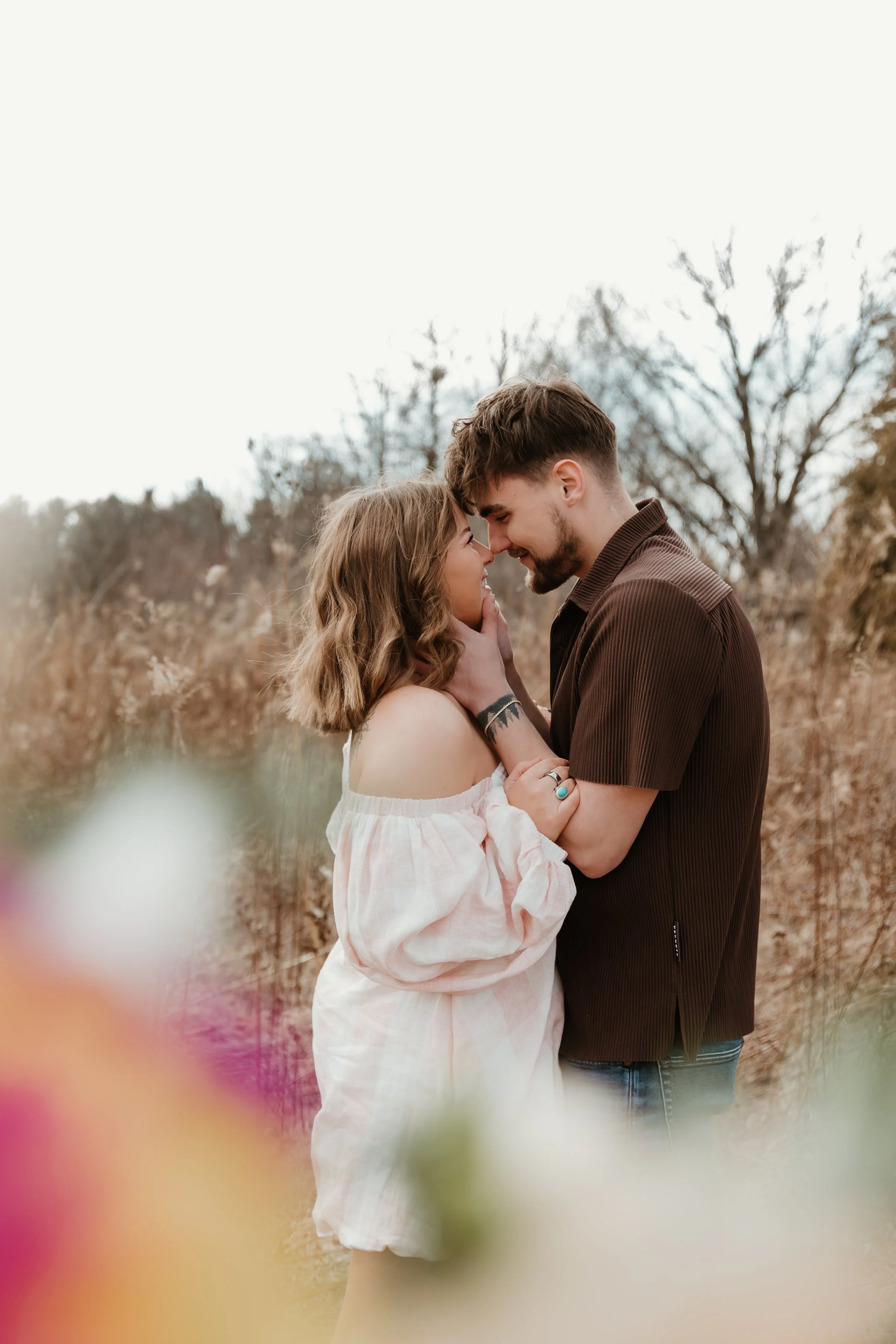 Couple embracing during a cold couples photoshoot at Donovan Park Peoria IL
