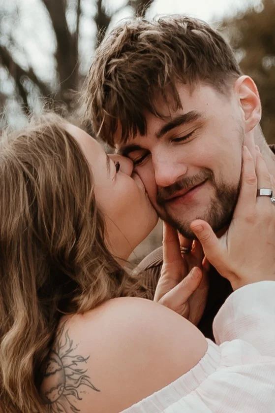 Close-up of couple smiling together during a couples session in Peoria Illinois Romantic couples photos in an open field at Donovan Park in Central Illinois