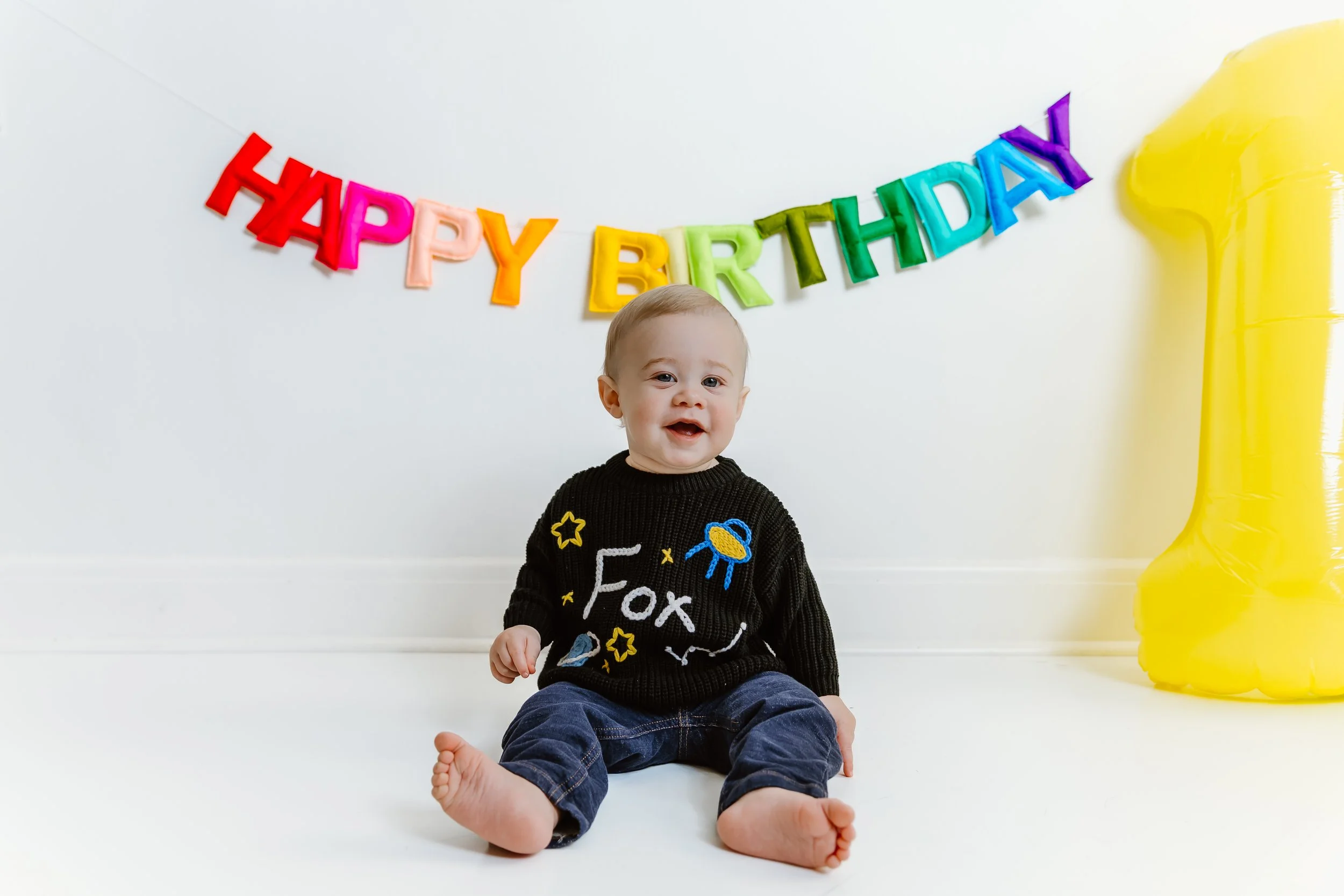 Happy baby boy portrait during first birthday milestone session
