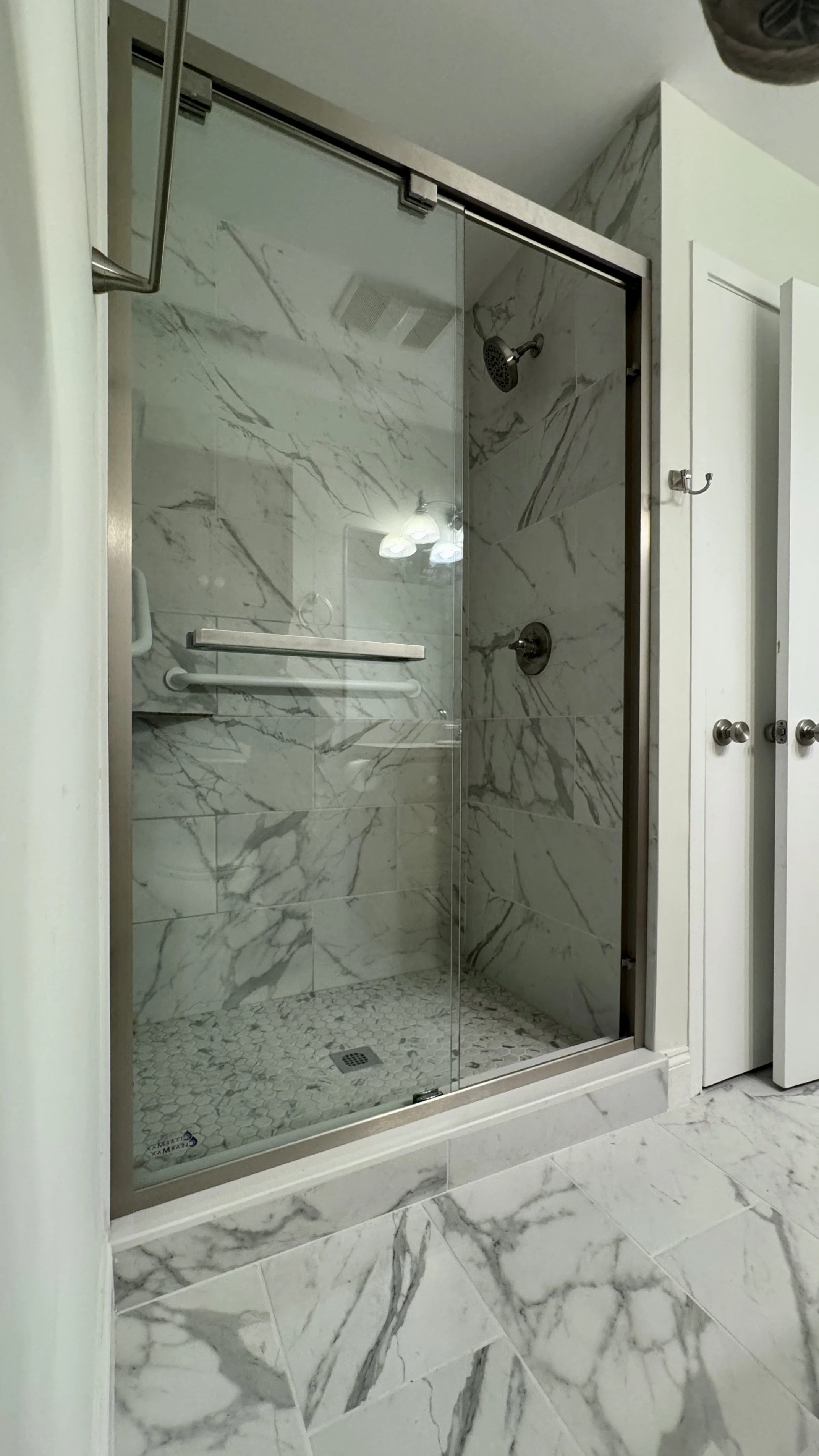 Aging in place bathroom remodel Putnam County NY with safe walk in shower, marble walls, grab bars, and modern bathroom renovation features.