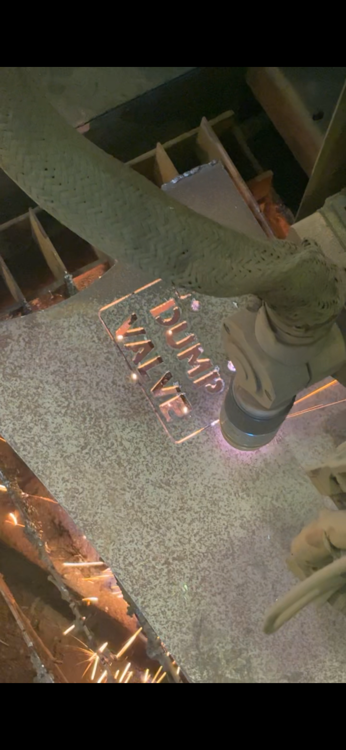 Plasma cutting machine at work on a metal sheet.