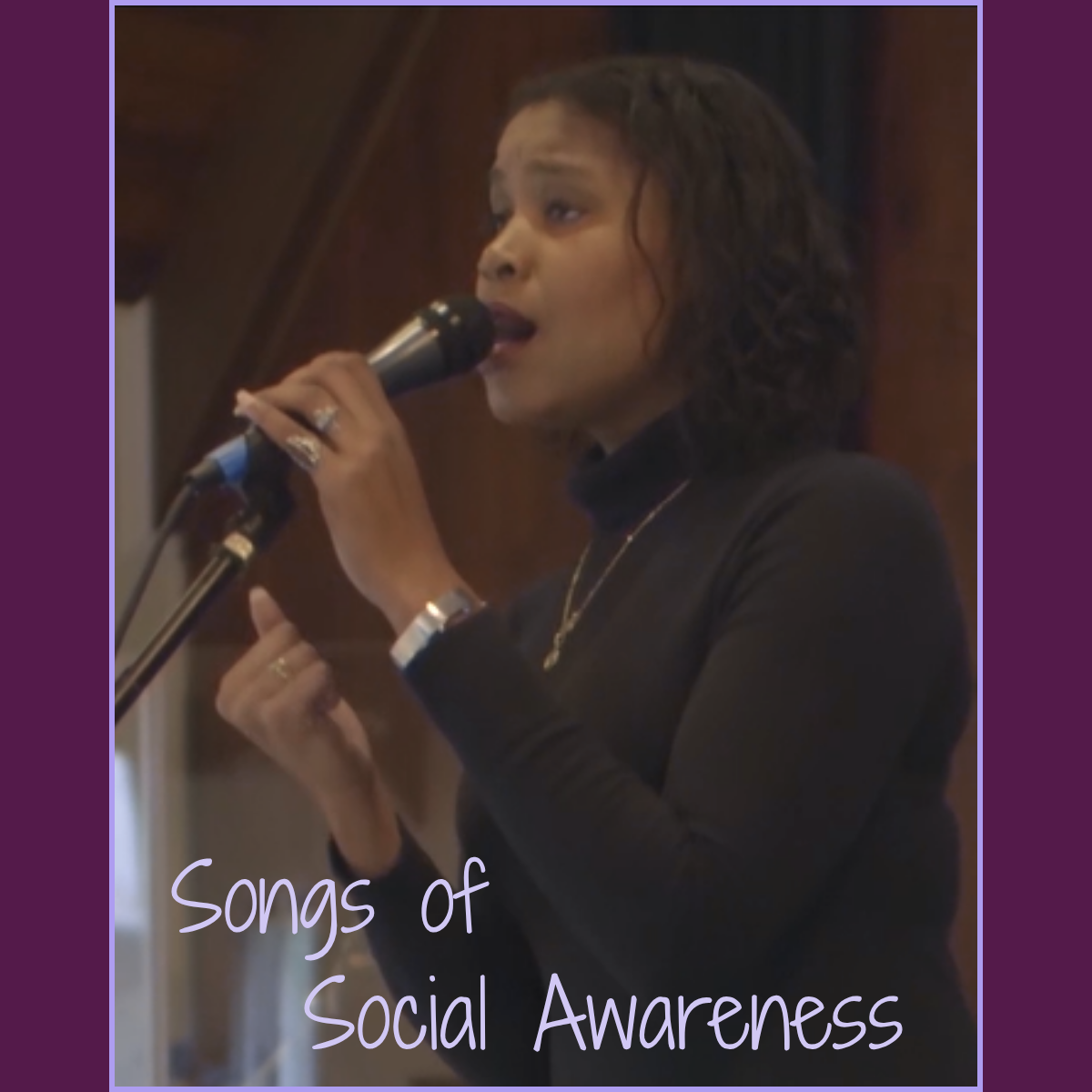 Whitney Parnell singing into a microphone during a performance, with the text “Songs of Social Awareness” overlaid on the image.