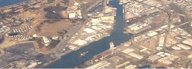 An aerial photograph shows the industrial waterfront of the United Heckathorn Superfund site along a canal in Richmond, California.