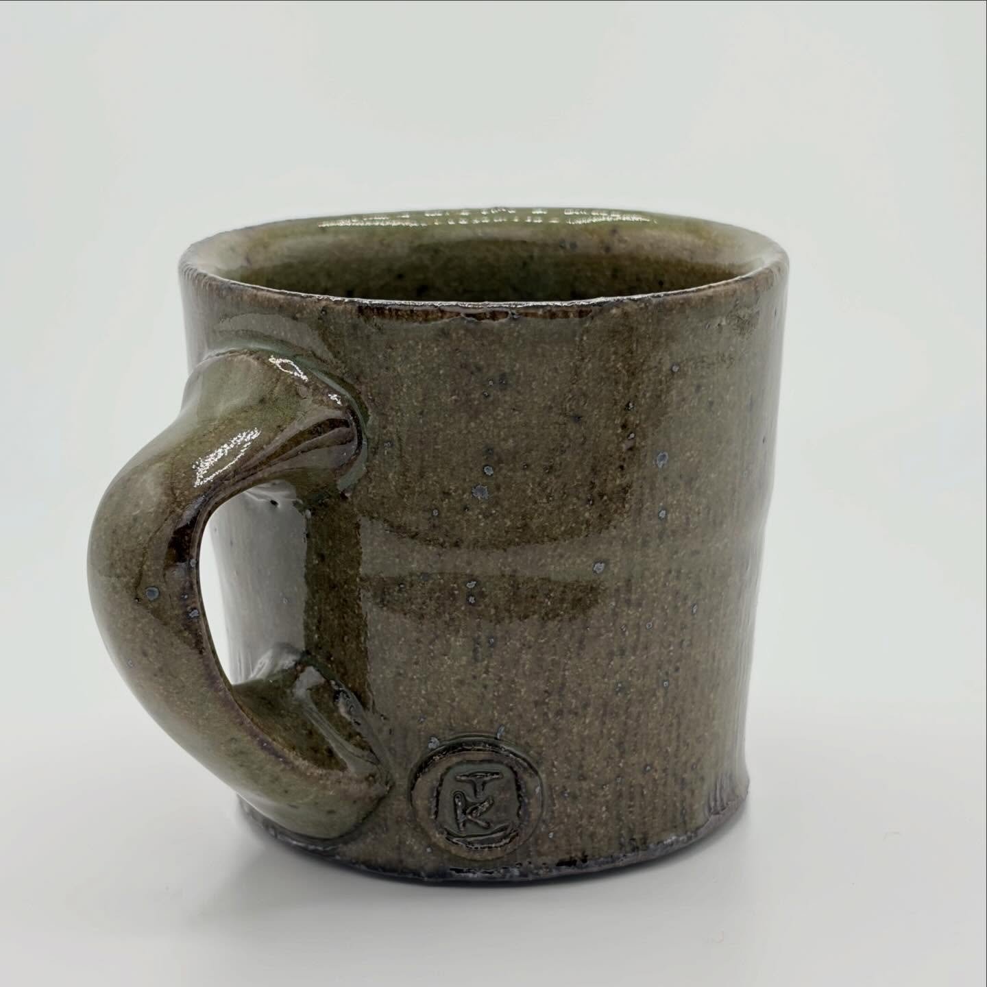 I love a small mug. For me, the challenge of a small mug is striking a balance between a pot that is small in dimensions but generous in other ways: in weight, in capacity, and overall feel in your hand. 

Stoneware, green celadon glaze, fired to ^10