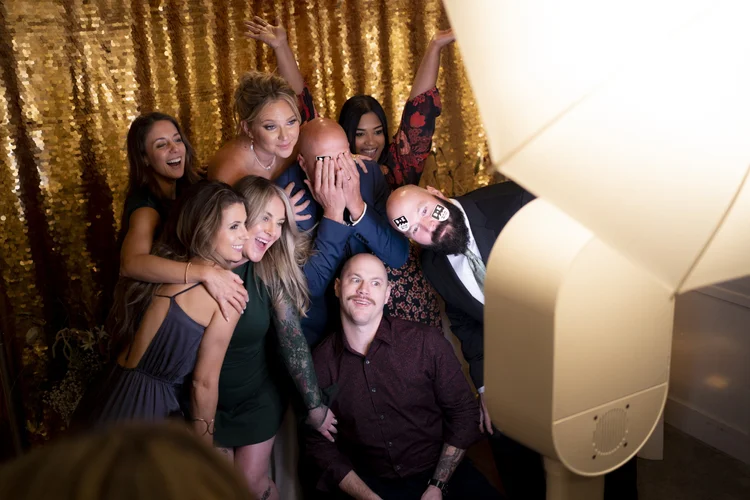 Group in front of gold sequin backdrop
