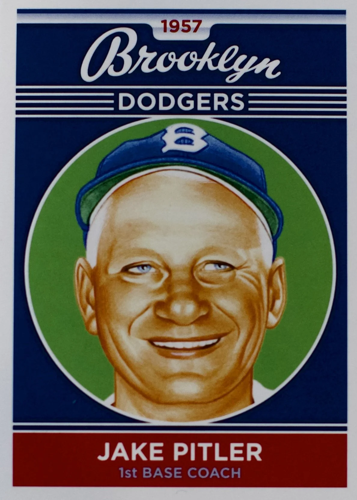 Vintage baseball card featuring Jake Pitler, a 1st base coach for the Brooklyn Dodgers, with a smiling portrait and the Brooklyn Dodgers logo, dated 1957.