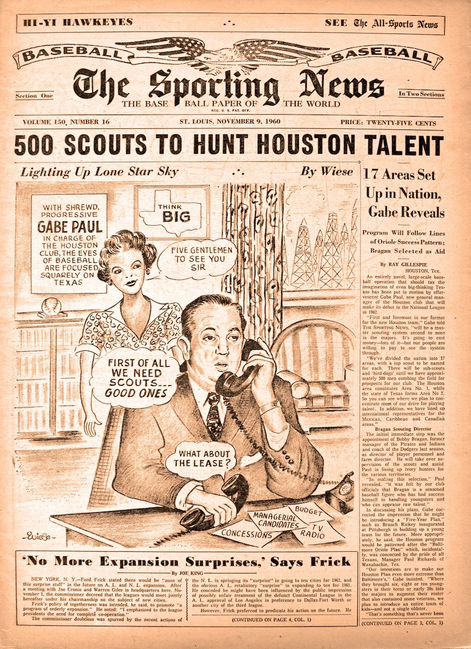 Front page of a 1960 sports newspaper titled 'The Sporting News,' featuring a comic illustration of Gabe Paul, a baseball executive, sitting at a desk with a telephone, and a woman standing behind him. The headline is about 500 scouts hunting Houston talent.