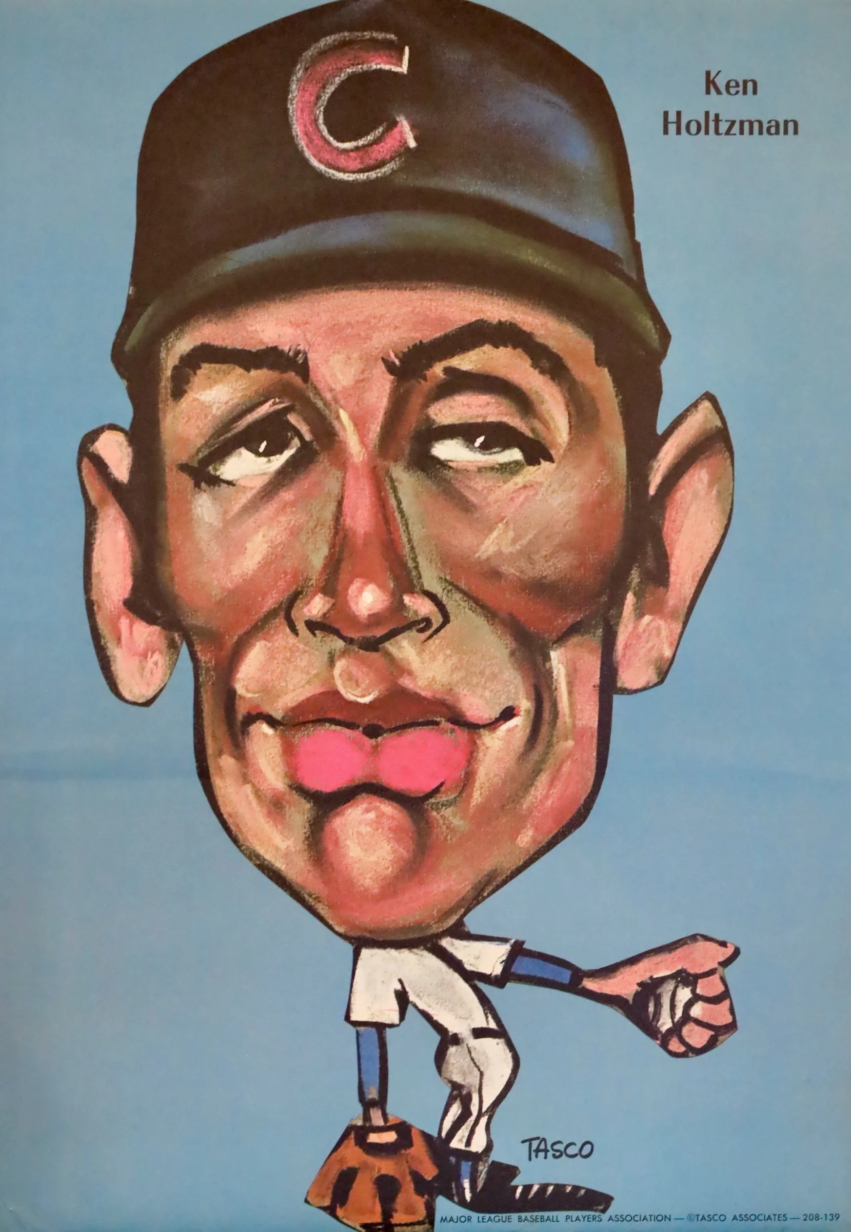 Cartoon caricature of a baseball player with large head, wearing a black cap with a red and white 'C' logo, and a small uniform, standing against a blue background. The name 'Ken Holtzman' is written on the right side, and 'TASCO' and 'Major League Baseball Players Association' are at the bottom.